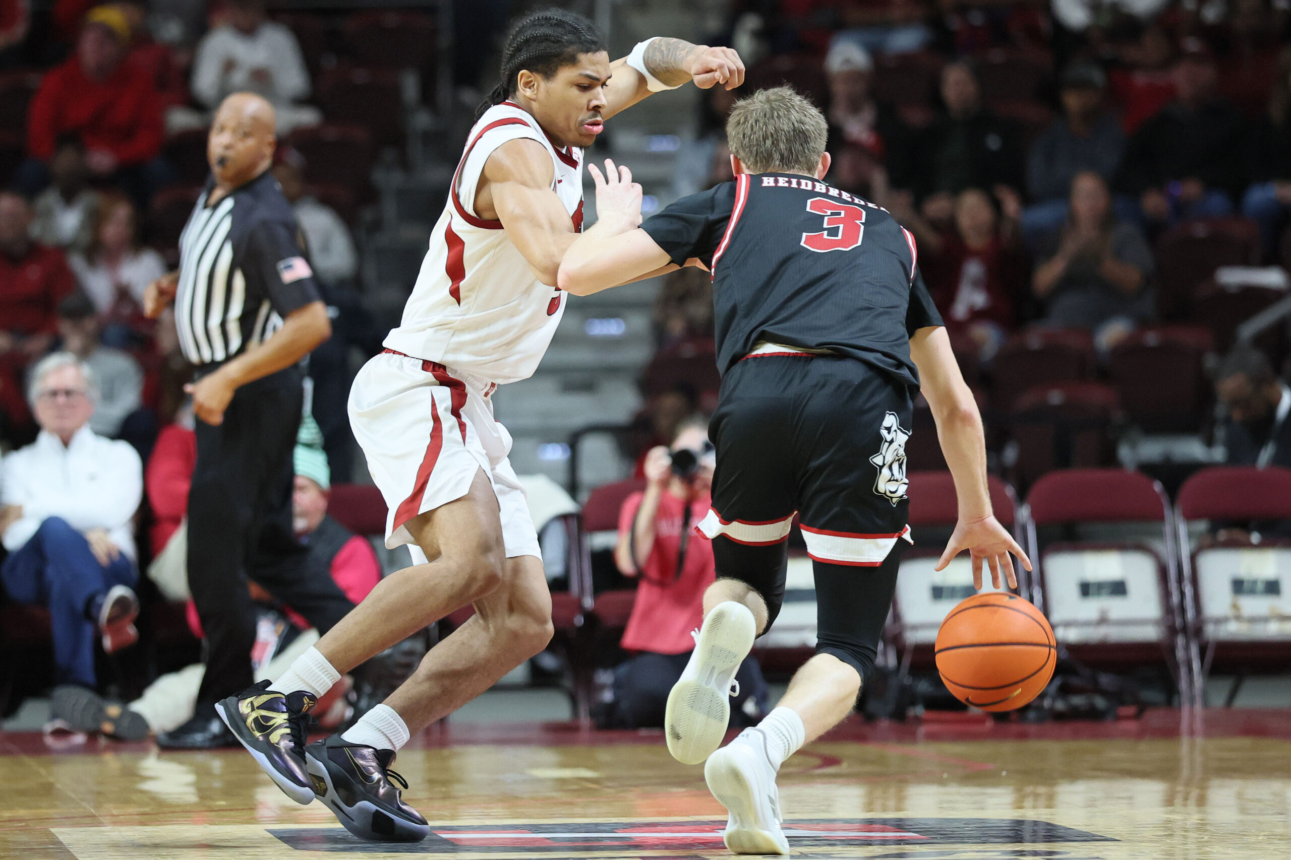 Dec 6, 2025; North Little Rock, Arkansas, USA; Arkansas Razorbacks guard Darius Acuff Jr (5) defends during the second half against Fresno State Bulldogs guard Jake Heidbreder (3) at Simmons Bank Arena. Arkansas won 82-58. Mandatory Credit: Nelson Chenault-Imagn Images