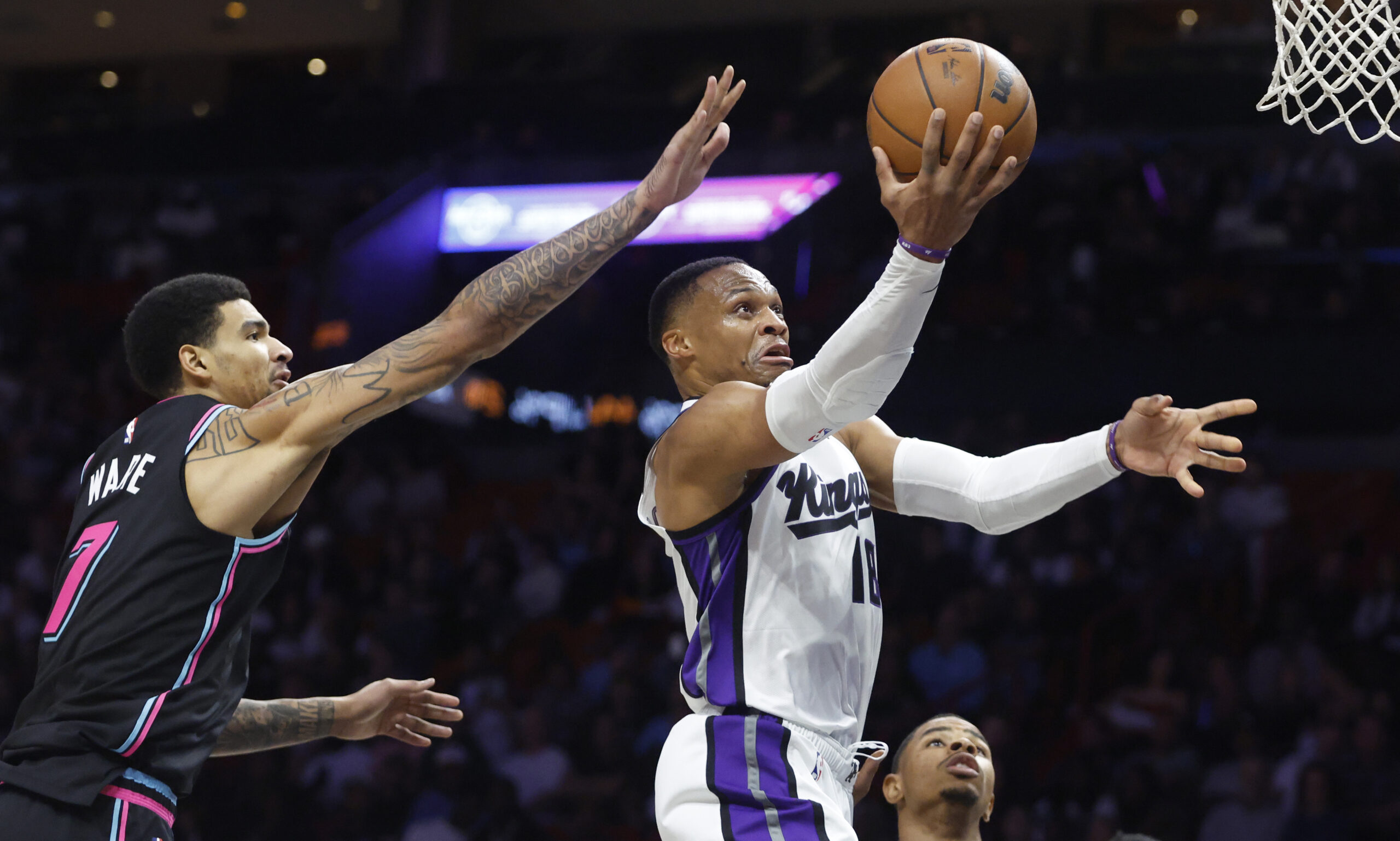 Dec 6, 2025; Miami, Florida, USA; Sacramento Kings guard Russell Westbrook (18) shoots around Miami Heat center Kel'el Ware (7) during the second half at Kaseya Center. Mandatory Credit: Rhona Wise-Imagn Images