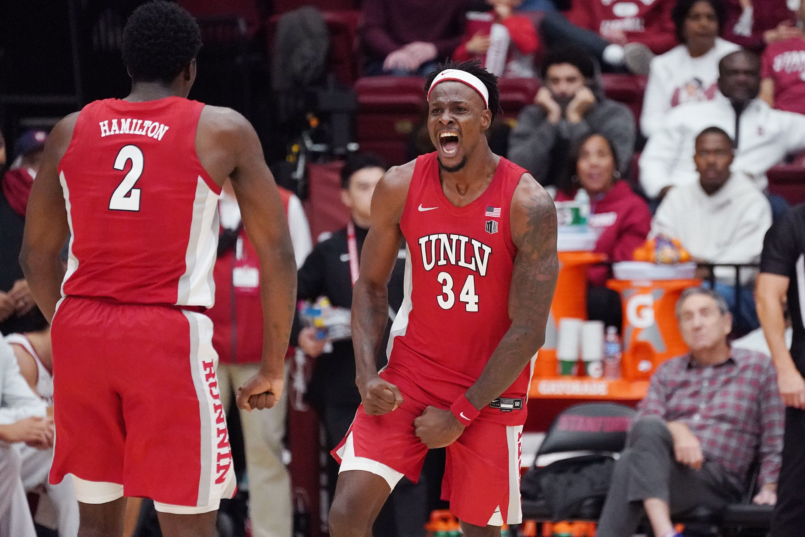 Dec 7, 2025; Stanford, California, USA;  UNLV Runnin' Rebels center Emmanuel Stephen (34) celebrates with UNLV Runnin' Rebels forward Kimani Hamilton (2) after a basket at the buzzer at the end of the first half at Maples Pavilion. Mandatory Credit: David Gonzales-Imagn Images
