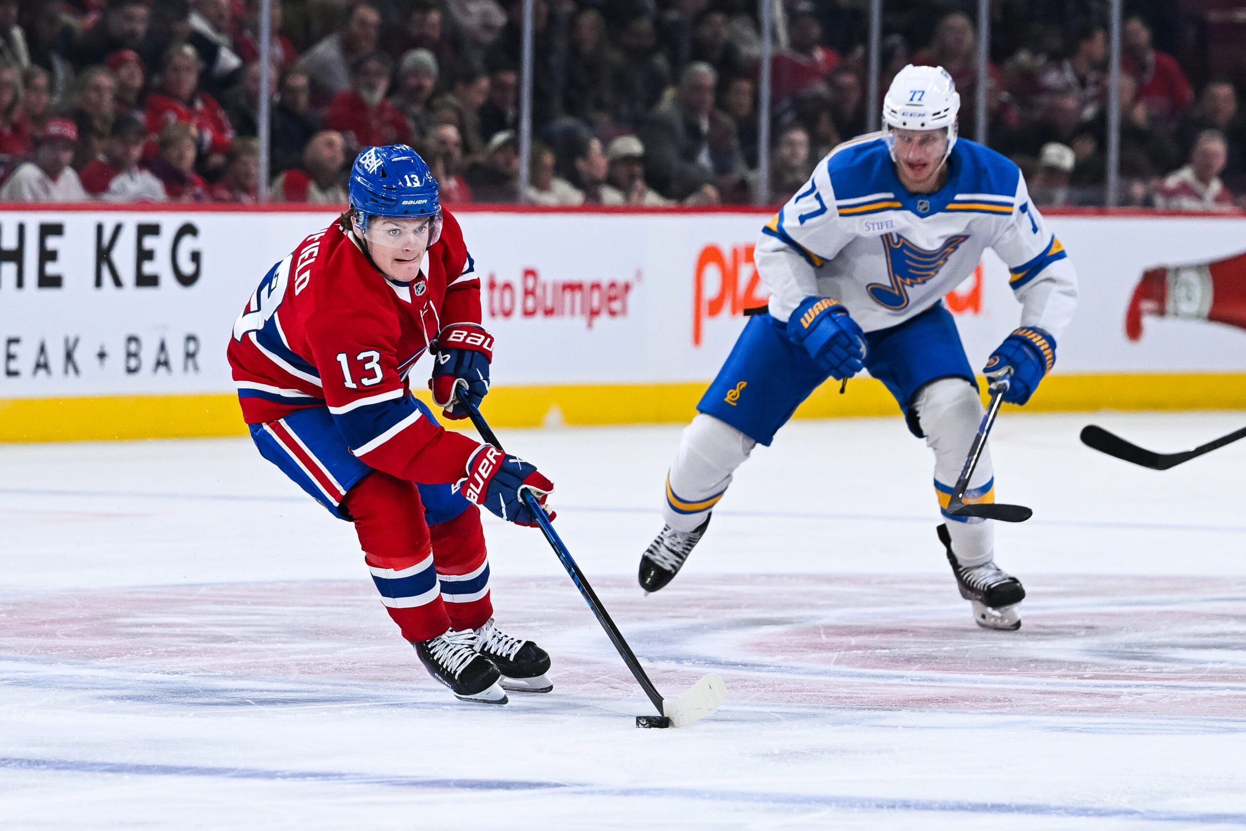 Dec 7, 2025; Montreal, Quebec, CAN; Montreal Canadiens right wing Cole Caufield (13) plays the puck against the St. Louis Blues during the third period at Bell Centre. Mandatory Credit: David Kirouac-Imagn Images