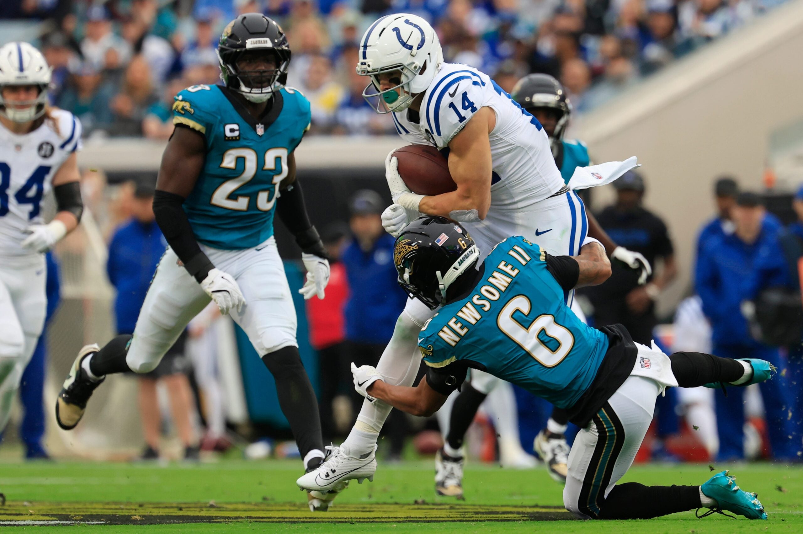 Indianapolis Colts wide receiver Alec Pierce (14) is tackled by acksonville Jaguars cornerback Greg Newsome II (6) during the first quarter of an NFL football game at EverBank Stadium, Sunday, Dec. 7, 2025, in Jacksonville, Fla. The Jaguars defeated the Colts 36-19.
