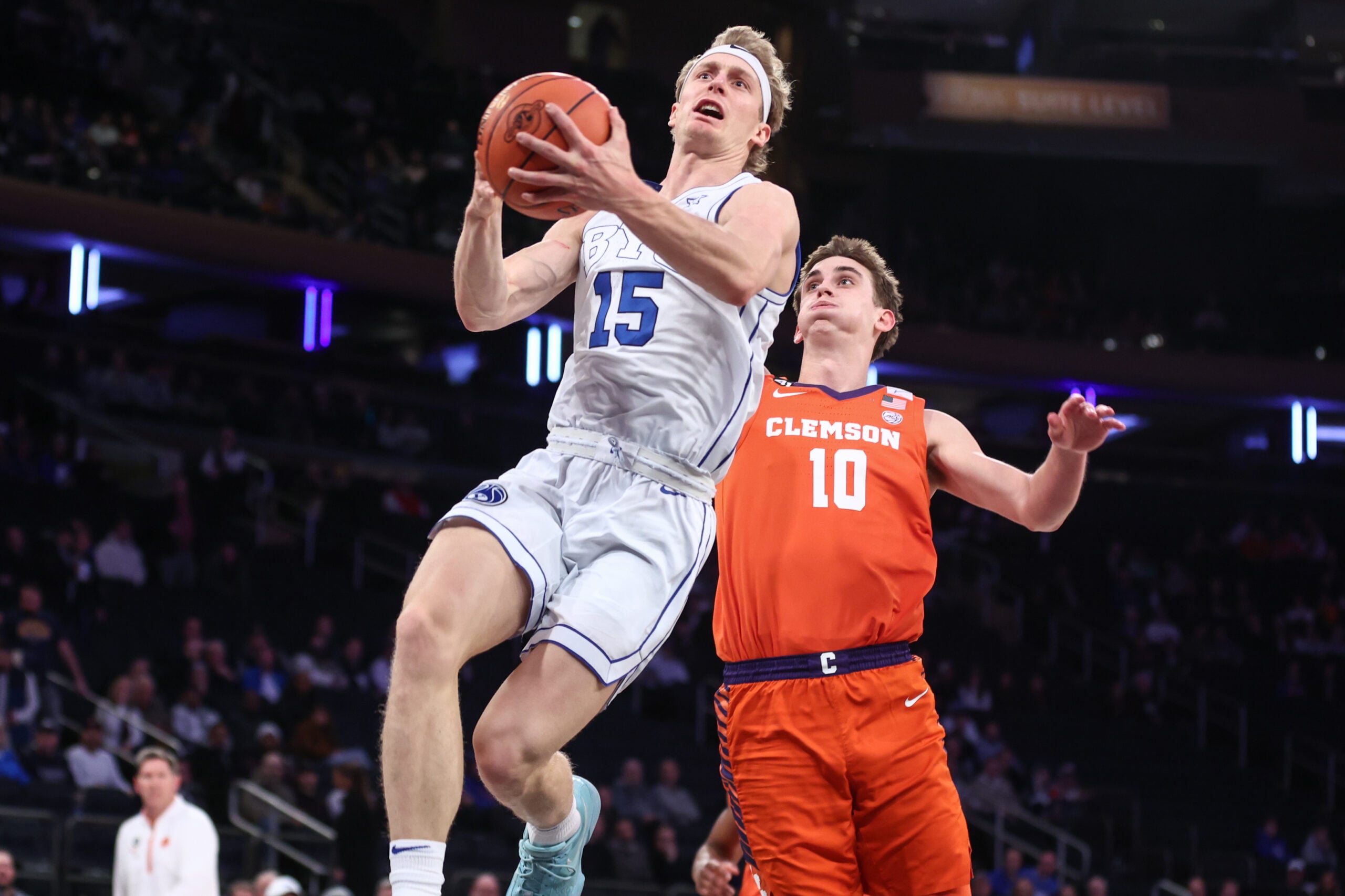 Dec 9, 2025; New York, New York, USA;  BYU Cougars guard Richie Saunders (15) drives past Clemson Tigers forward Jake Wahlin (10) in the first half at Madison Square Garden. Mandatory Credit: Wendell Cruz-Imagn Images