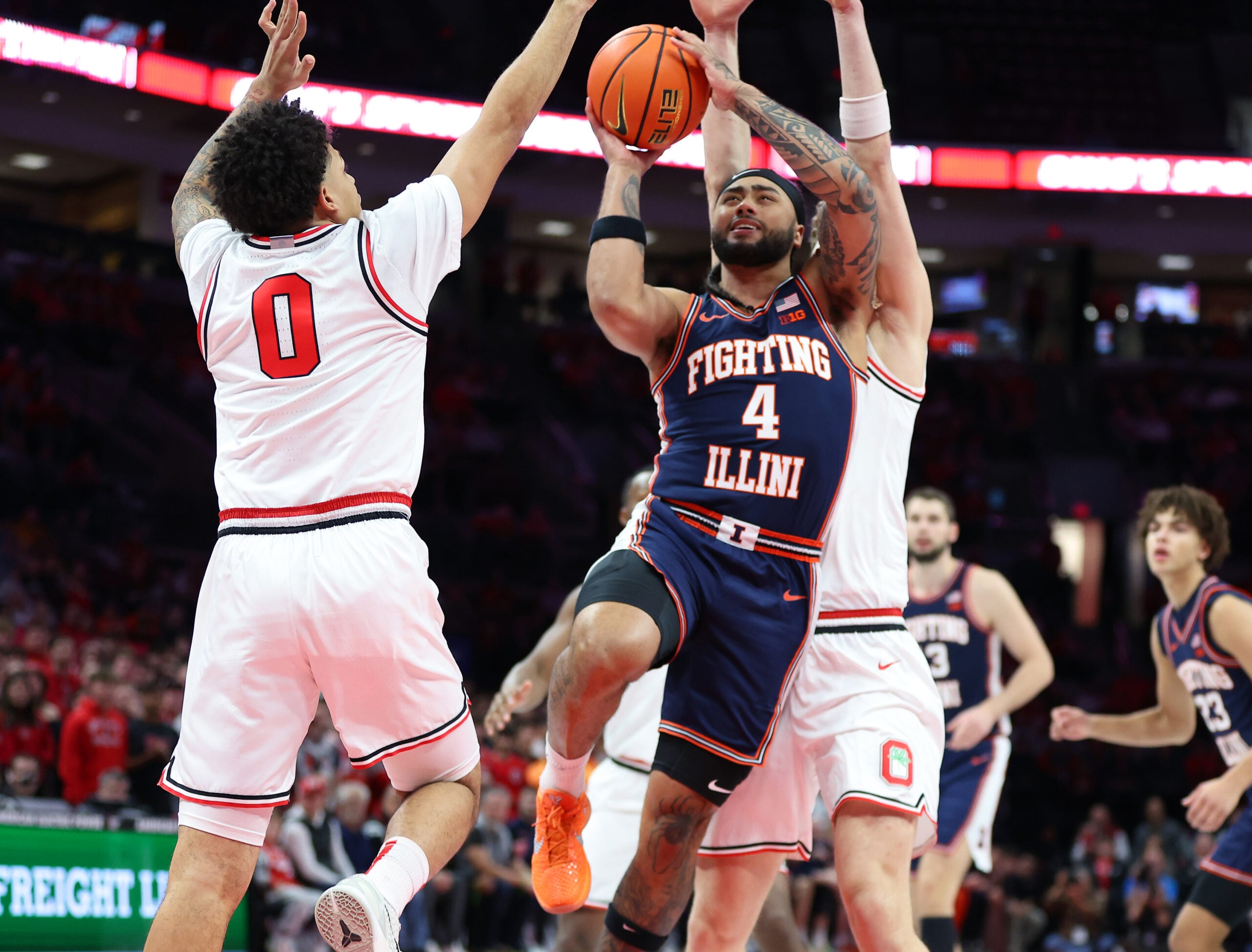 Dec 9, 2025; Columbus, Ohio, USA;  Illinois Fighting Illini guard Kylan Boswell (4) drives to the basket as Ohio State Buckeyes guard John Mobley Jr. (0) defends during the first half Value City Arena. Mandatory Credit: Joseph Maiorana-Imagn Images