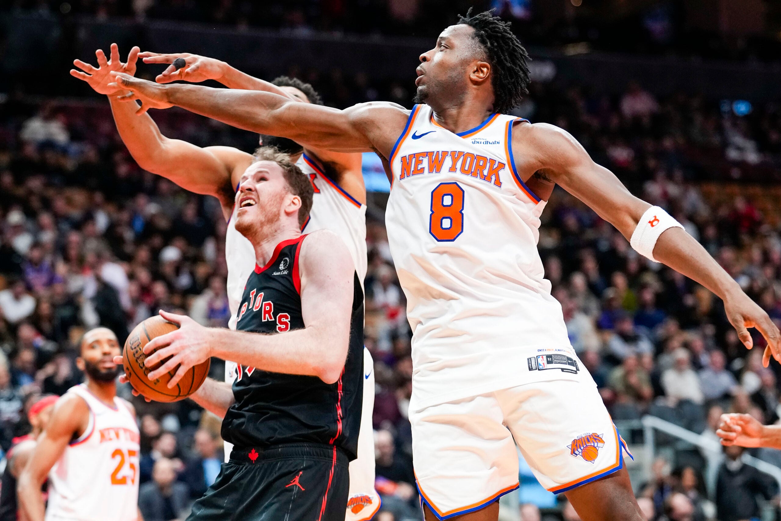 Dec 9, 2025; Toronto, Ontario, CAN; Toronto Raptors center Jakob Poeltl (19) drives to the basket against New York Knicks forward Og Anunoby (8) during the second half at the 2025-26 NBA Emirates Cup at Scotiabank Arena. Mandatory Credit: Kevin Sousa-Imagn Images