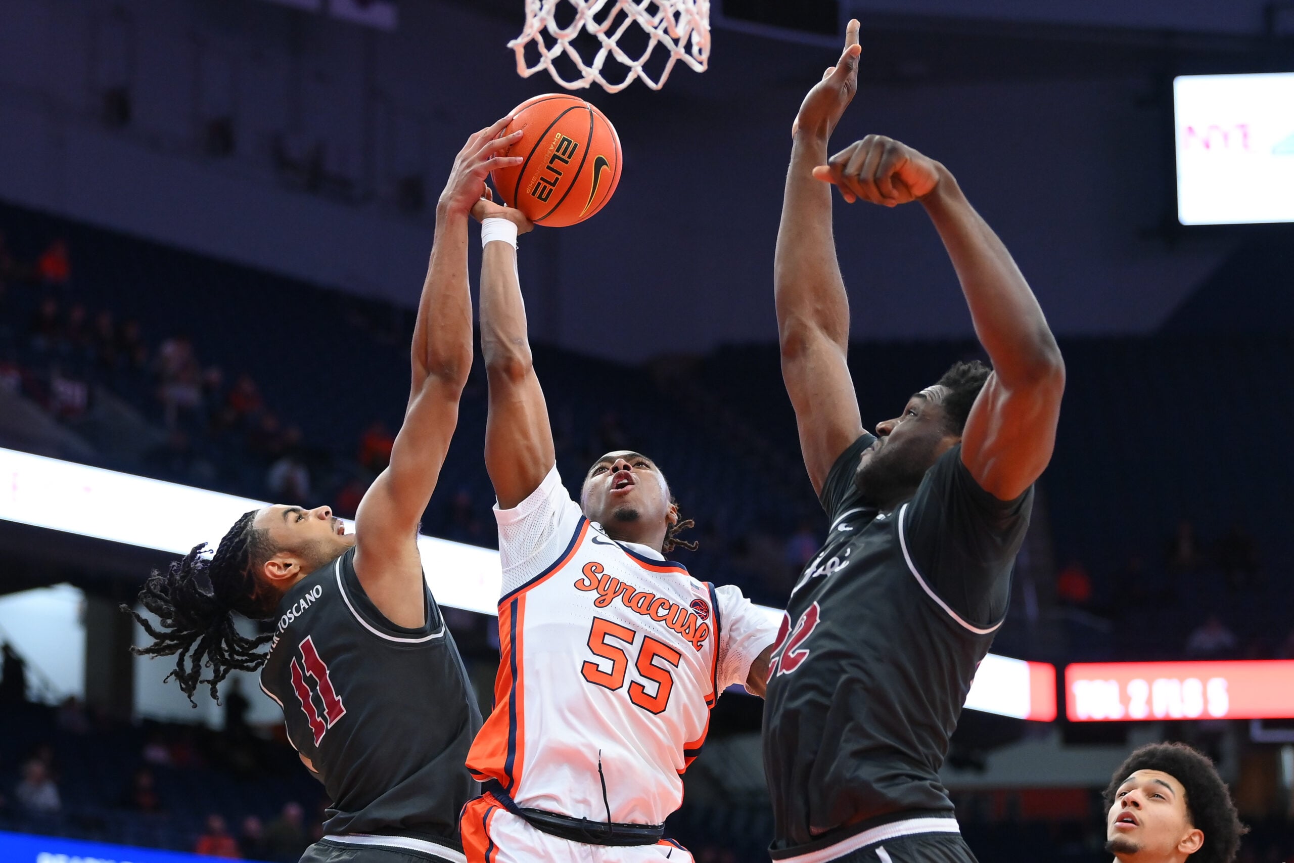 Dec 11, 2025; Syracuse, New York, USA; Saint Joseph's Hawks guard Jaiden Glover-Toscano (11) blocks the shot of Syracuse Orange guard Bryce Zephir (55) during the second half at the JMA Wireless Dome. Mandatory Credit: Rich Barnes-Imagn Images