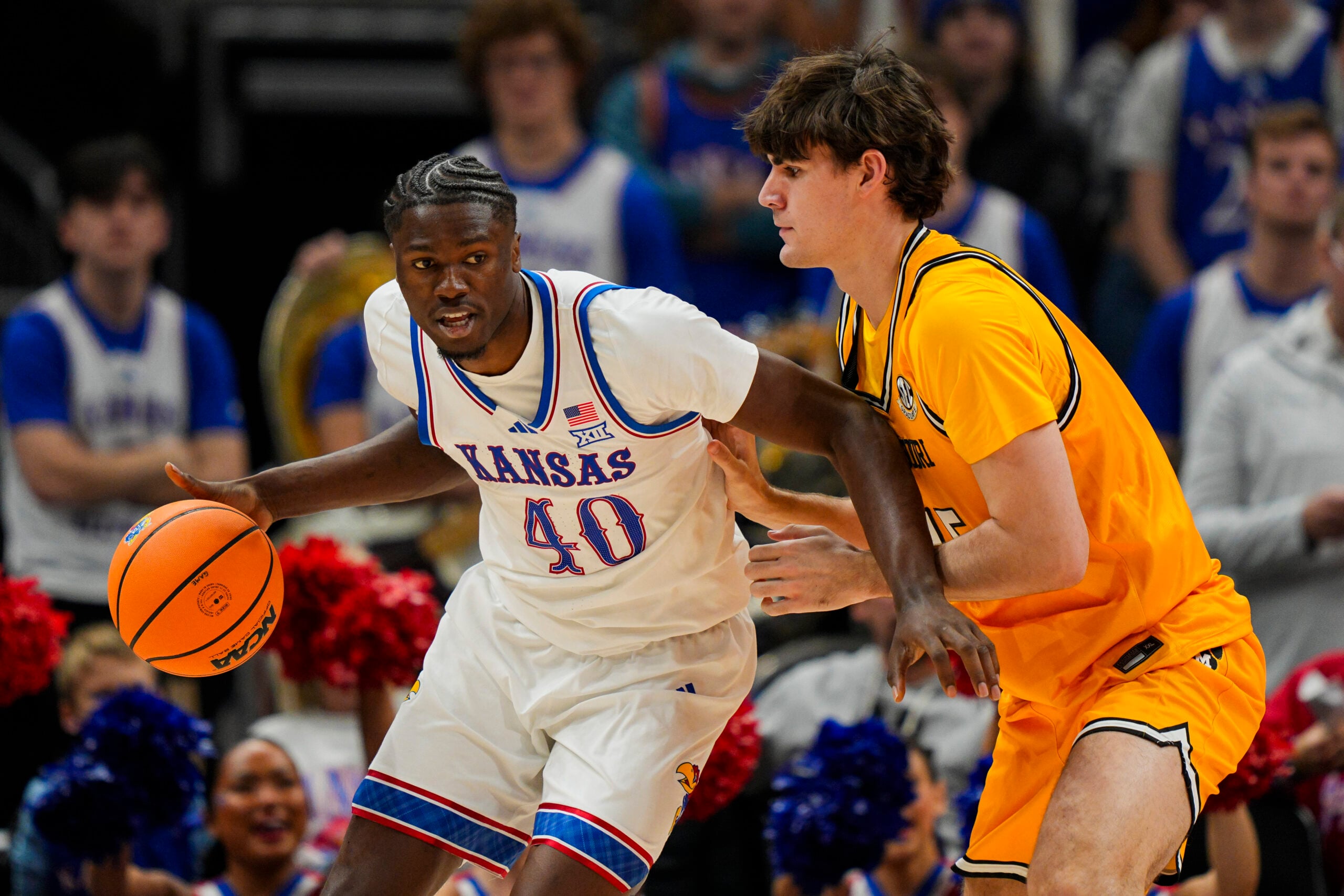 Dec 7, 2025; Kansas City, Missouri, USA; Kansas Jayhawks forward Flory Bidunga (40) dribbles the ball against Missouri Tigers forward Luke Northweather (45) during the second half at T-Mobile Center. Mandatory Credit: Jay Biggerstaff-Imagn Images