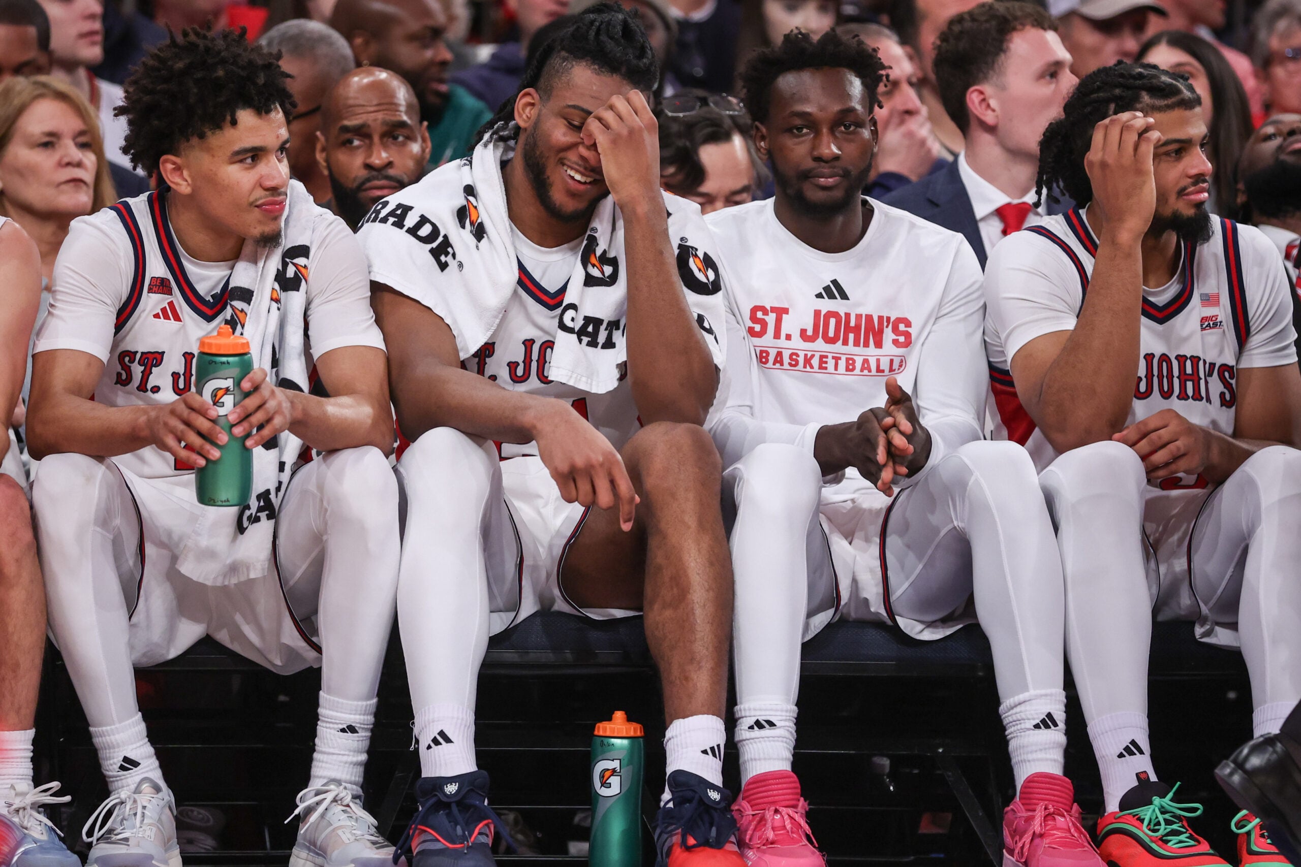 Dec 13, 2025; Queens, New York, USA; St. John's Red Storm guard Oziyah Sellers (4), forwards Zuby Ejiofor (24), Sadiku Ibine Ayo (2) and Bryce Hopkins (23) sit on the bench in the second half against the Iona Gaels at Madison Square Garden. Mandatory Credit: Wendell Cruz-Imagn Images