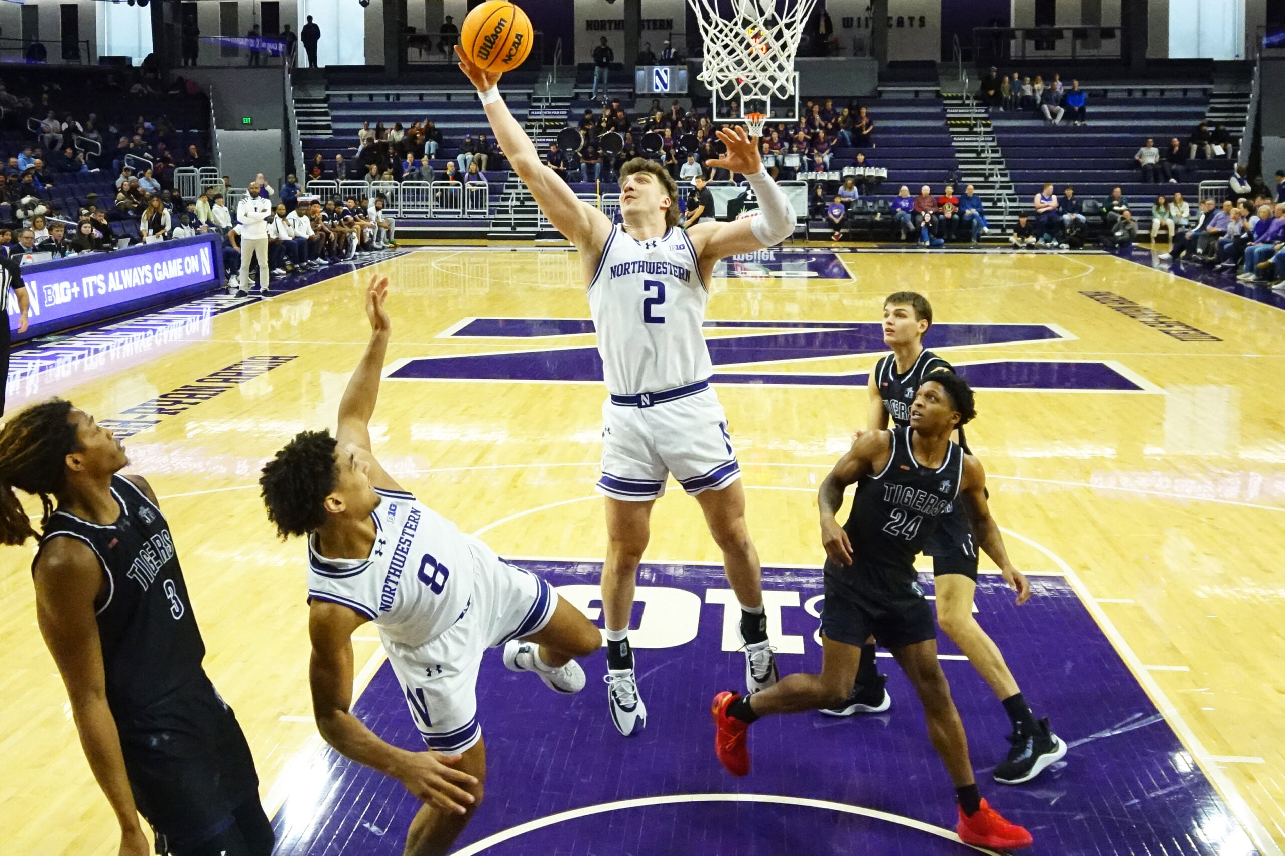 Dec 13, 2025; Evanston, Illinois, USA; Northwestern Wildcats forward Nick Martinelli (2) grabs a rebound in front of Jackson State Tigers guard Daeshun Ruffin (24) during the first half at Welsh-Ryan Arena. Mandatory Credit: David Banks-Imagn Images