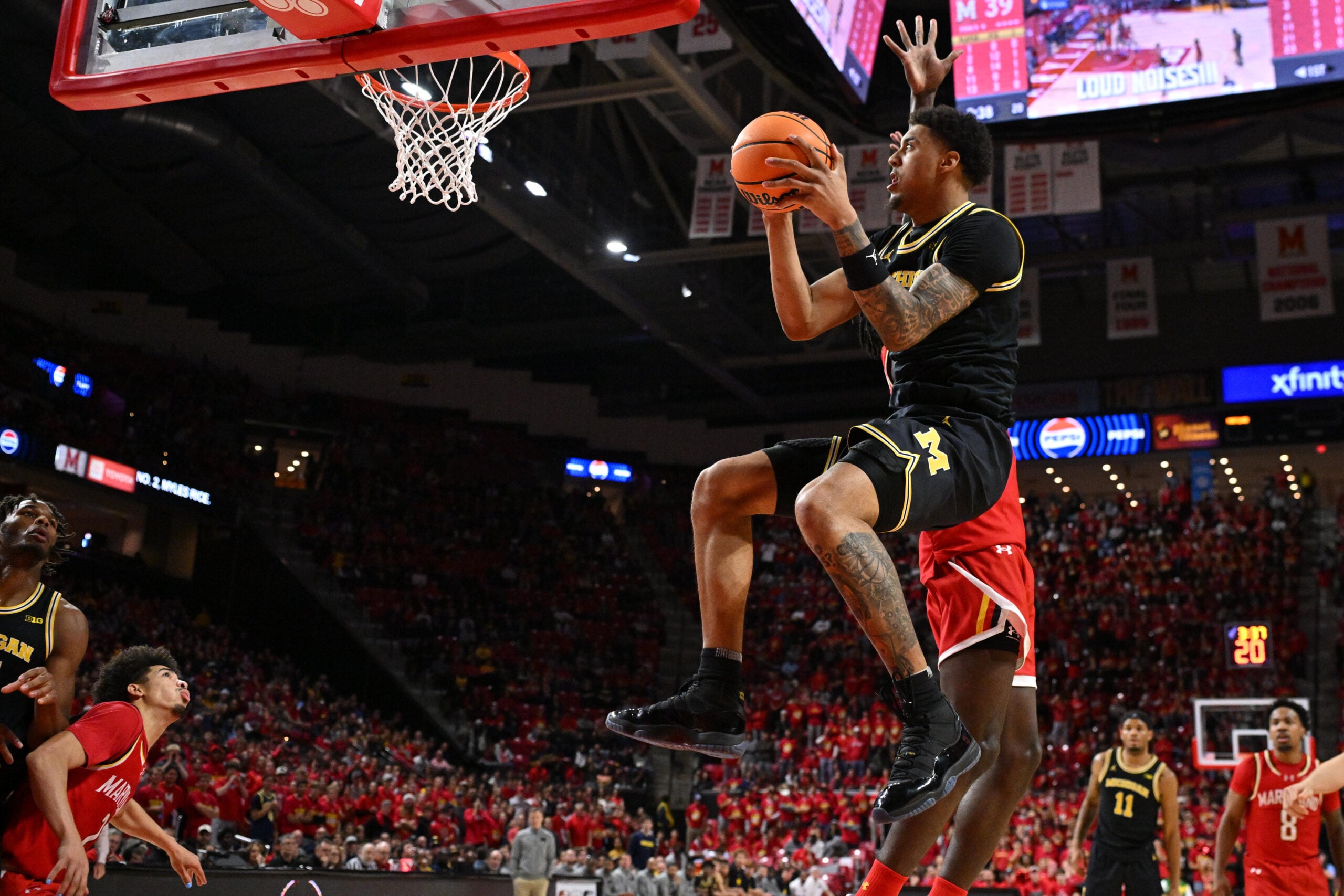 Dec 13, 2025; College Park, Maryland, USA; Michigan Wolverines forward Yaxel Lendeborg (23) drives to the basket for a lay up in the first half against the Maryland Terrapins at Xfinity Center. Mandatory Credit: Jamie Sabau-Imagn Images