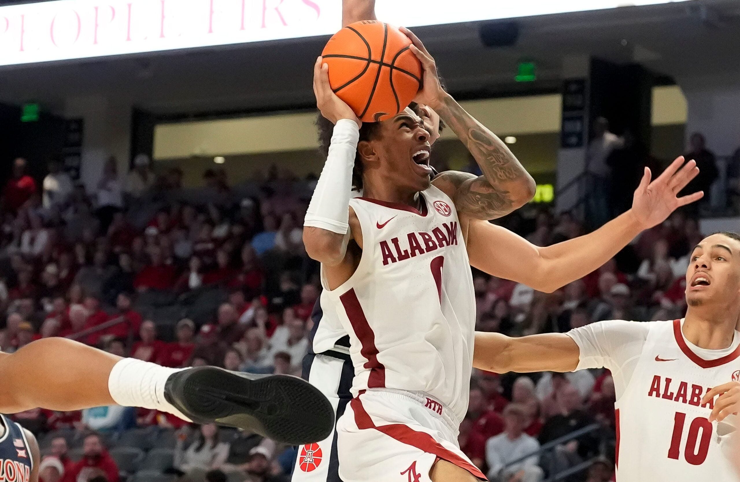 Dec 13, 2025; Birmingham, AL, USA; Alabama guard Labaron Philon Jr. (0) fights his way to the basket for a shot against Arizona at Legacy Arena. Mandatory Credit: Gary Cosby Jr.-Tuscaloosa News