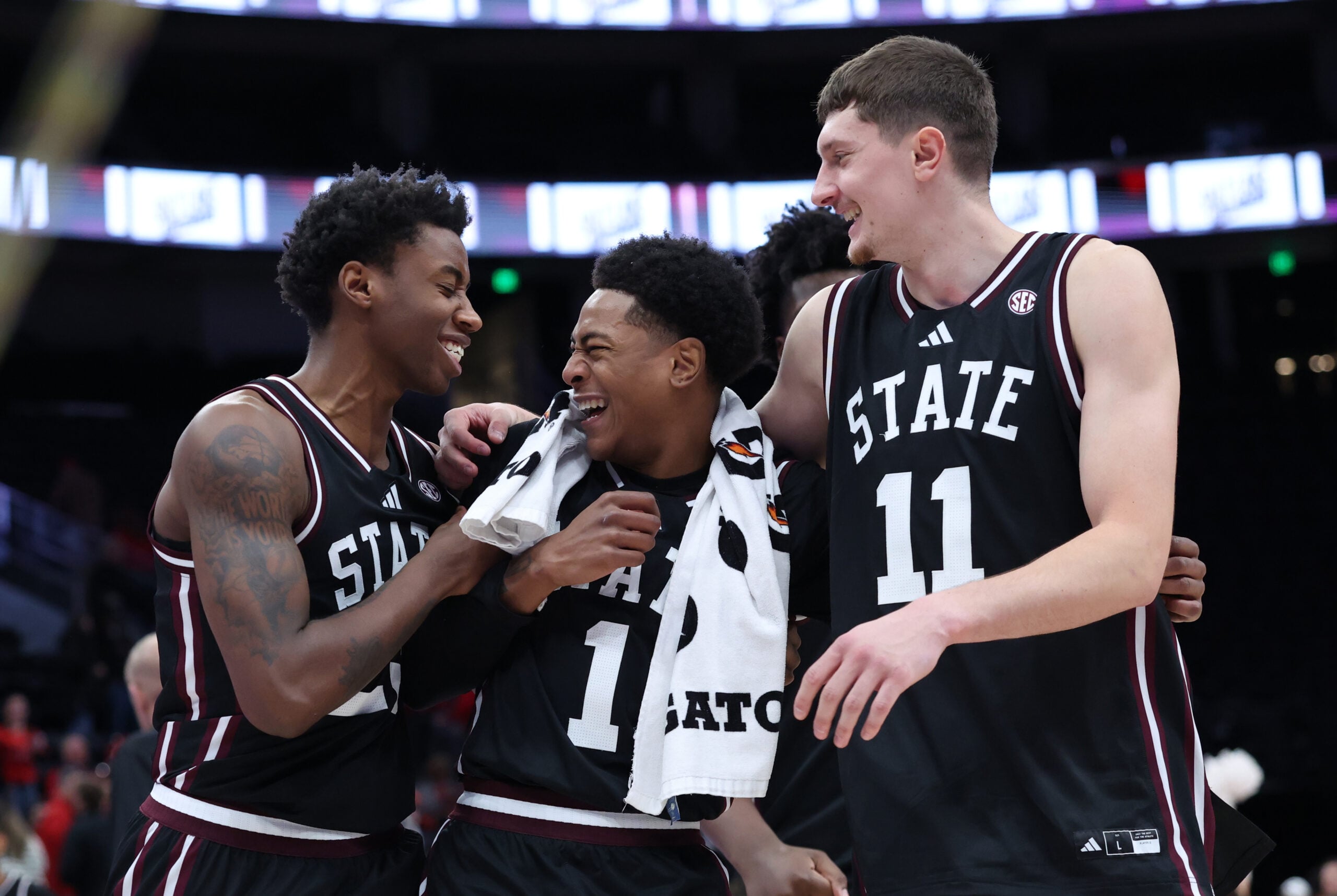 Dec 13, 2025; Salt Lake City, Utah, USA; Mississippi State Bulldogs guard King Grace (23) along with guard Dellquan Warren (1) and forward Sergej MacUra (11) celebrate a win over the Utah Utes after the game at Delta Center. Mandatory Credit: Rob Gray-Imagn Images
