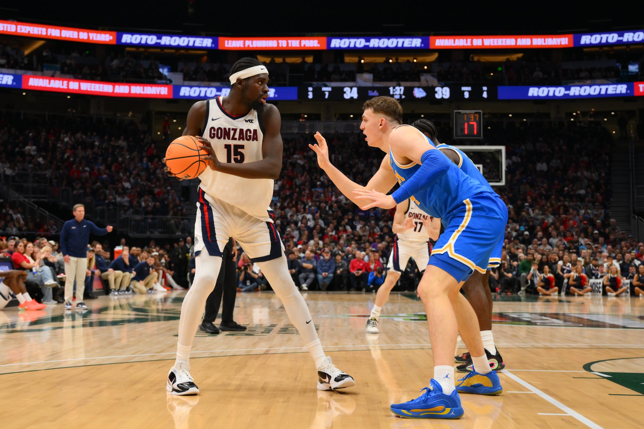 Dec 13, 2025; Seattle, Washington, USA; Gonzaga Bulldogs forward Graham Ike (15) is guarded by UCLA Bruins forward Tyler Bilodeau (34) during the first half at Climate Pledge Arena. Mandatory Credit: Steven Bisig-Imagn Images