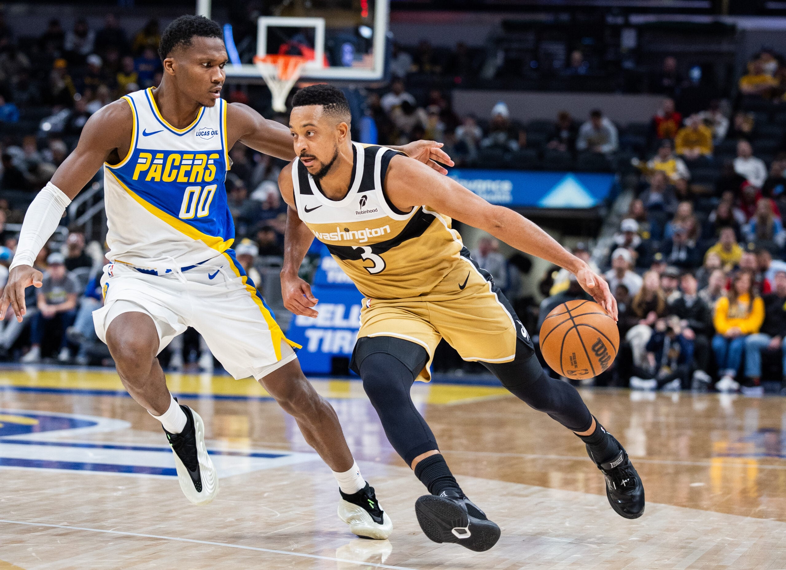 Dec 14, 2025; Indianapolis, Indiana, USA; Washington Wizards guard CJ McCollum (3) dribbles the ball while Indiana Pacers guard/forward Bennedict Mathurin (00) defends in the second half at Gainbridge Fieldhouse. Mandatory Credit: Trevor Ruszkowski-Imagn Images
