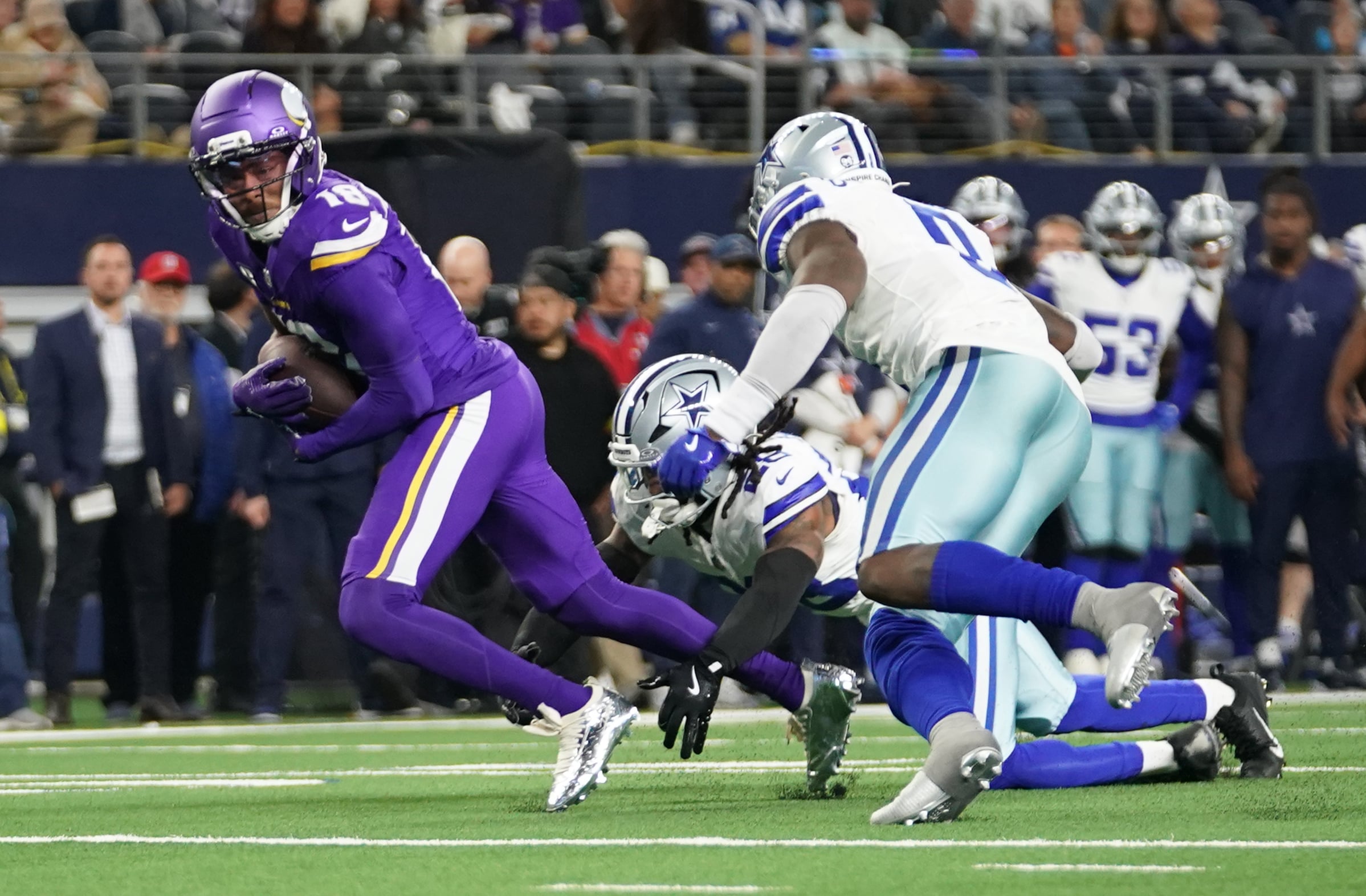 Dec 14, 2025; Arlington, Texas, USA; Minnesota Vikings wide receiver Justin Jefferson (18) runs against Dallas Cowboys safety Malik Hooker (28) and linebacker Demarvion Overshown (0) during the second half at AT&T Stadium. Mandatory Credit: Raymond Carlin III-Imagn Images