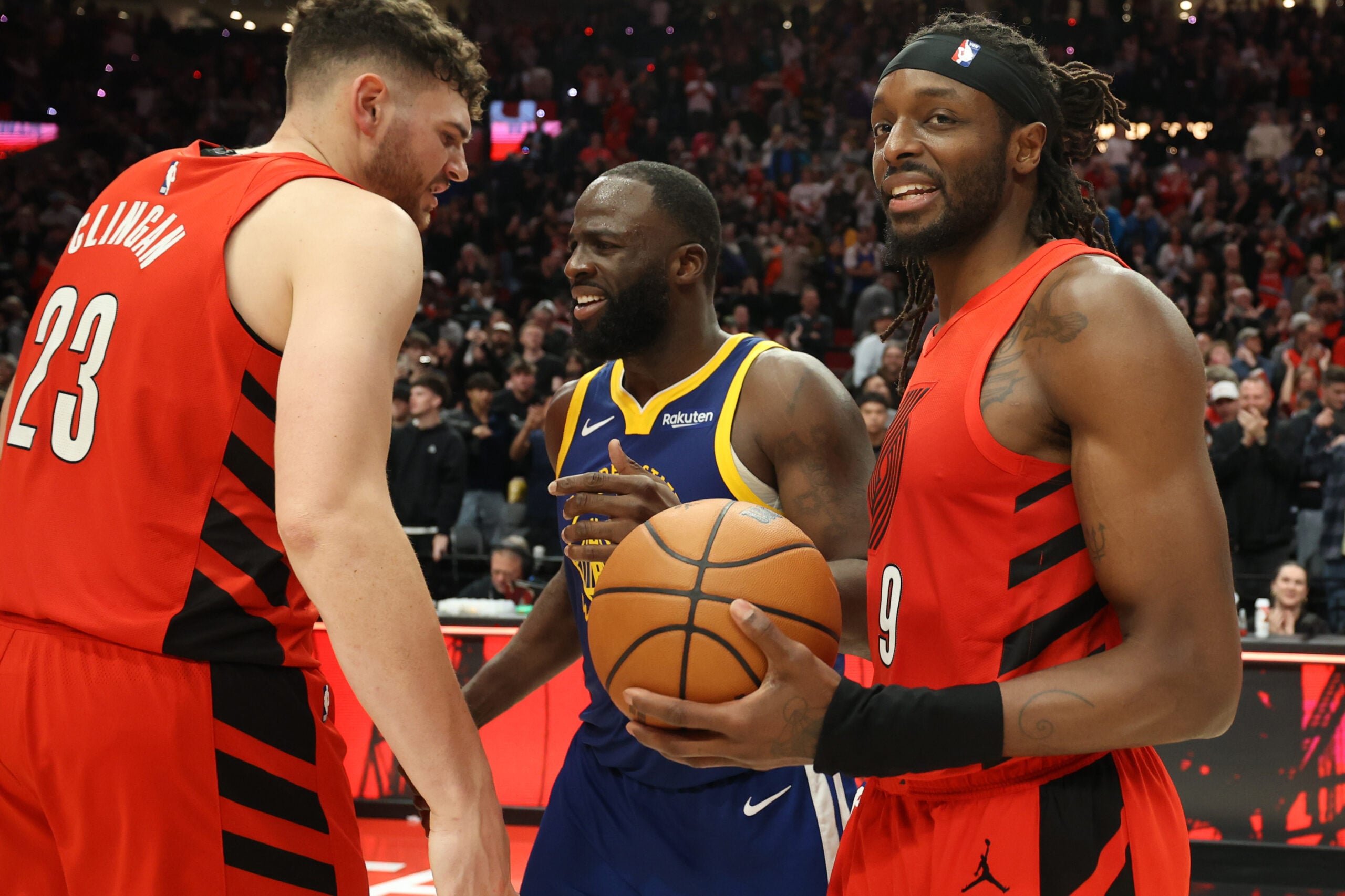 Dec 14, 2025; Portland, Oregon, USA; Portland Trail Blazers forward Jerami Grant (9) reacts after the game as center Donovan Clingan (23) talks with Golden State Warriors forward Draymond Green (23) at Moda Center. Mandatory Credit: Jaime Valdez-Imagn Images
