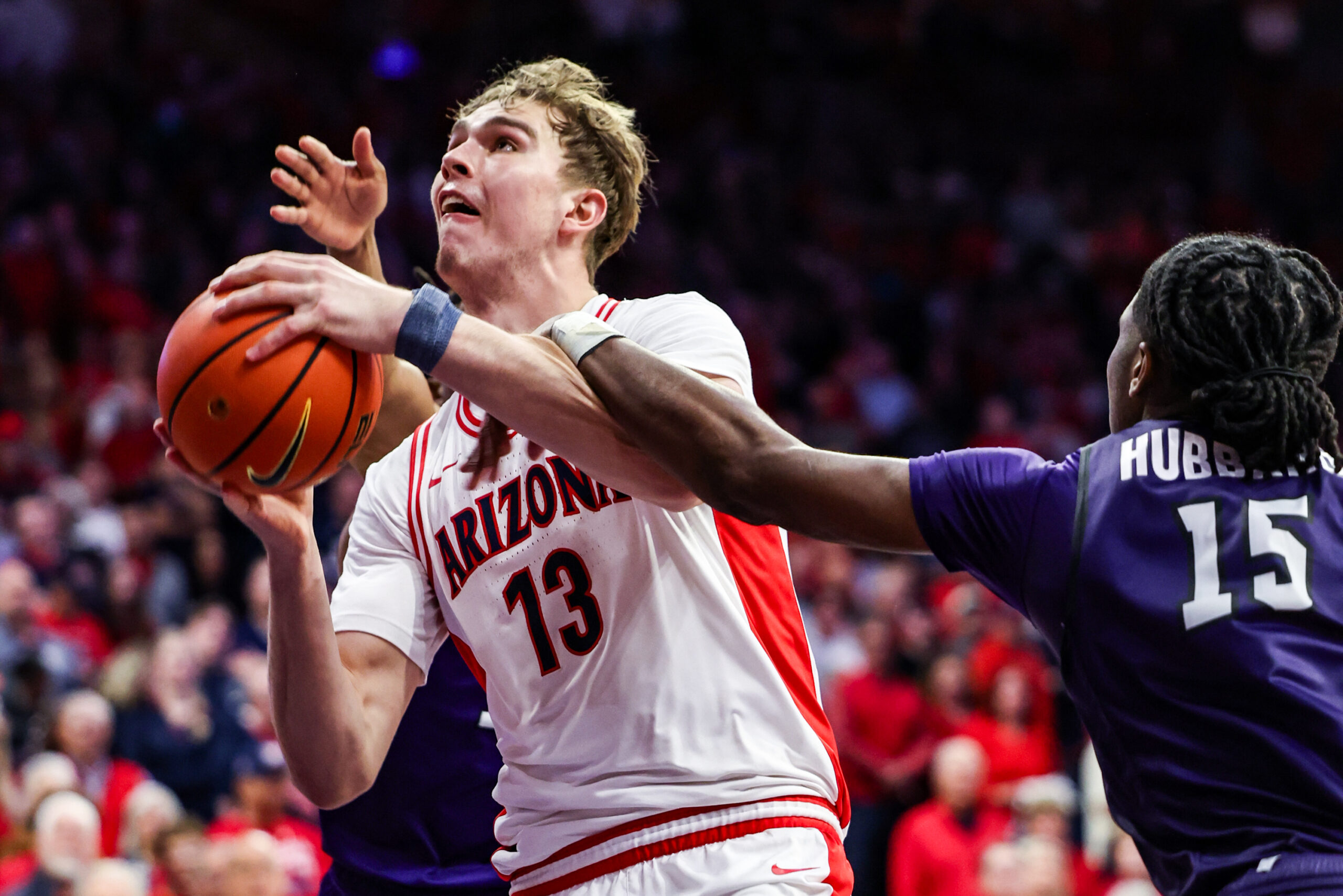 Dec 16, 2025; Tucson, Arizona, USA; Abilene Christian Wildcats forward Bradyn Hubbard (15) fouls Arizona Wildcats center Motiejus Krivas (13) during the second of the game at McKale Memorial Center. Mandatory Credit: Aryanna Frank-Imagn Images