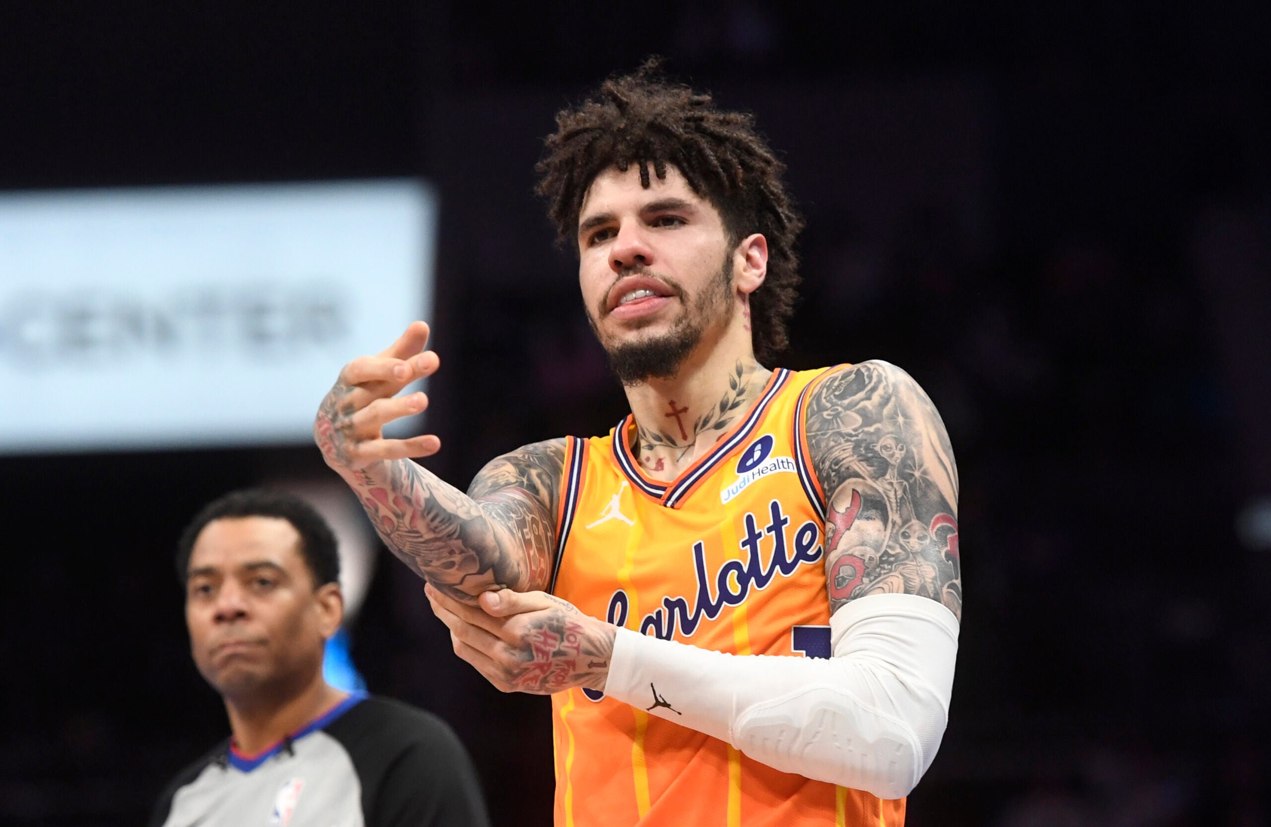 Dec 18, 2025; Charlotte, North Carolina, USA;  Charlotte Hornets guard LaMelo Ball (1) rubs his elbow after falling during the second half against the Atlanta Hawks at the Spectrum Center. Mandatory Credit: Sam Sharpe-Imagn Images