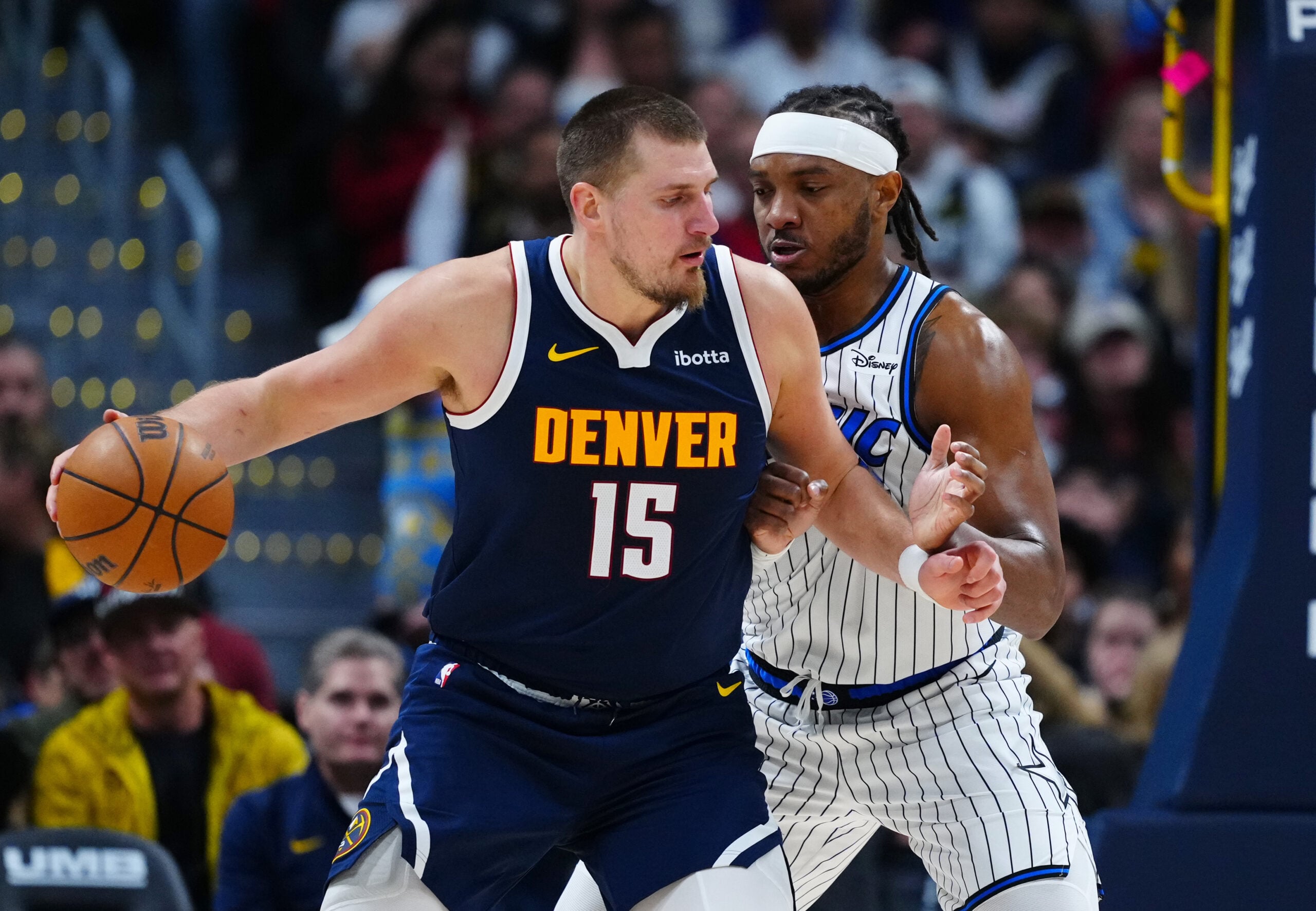 Dec 18, 2025; Denver, Colorado, USA; Orlando Magic center Wendell Carter Jr. (34) defends on Denver Nuggets center Nikola Jokic (15) during the second half at Ball Arena. Mandatory Credit: Ron Chenoy-Imagn Images