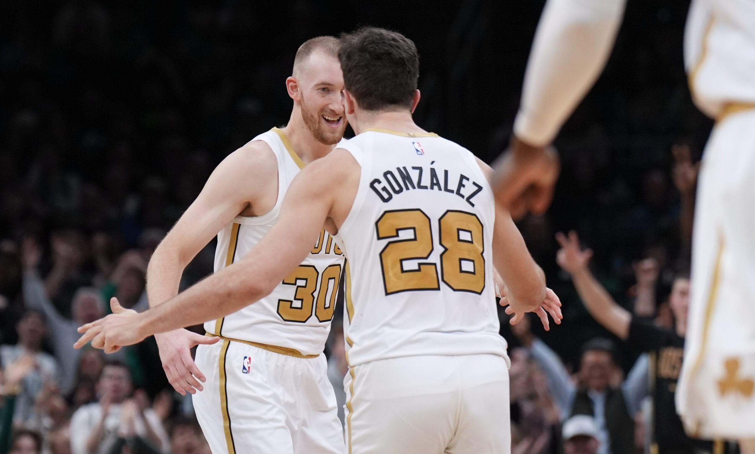 Dec 19, 2025; Boston, Massachusetts, USA; Boston Celtics forward Sam Hauser (30) reacts after his three point basket with guard Hugo Gonzalez (28) against the Miami Heat in the second half at TD Garden. Mandatory Credit: David Butler II-Imagn Images