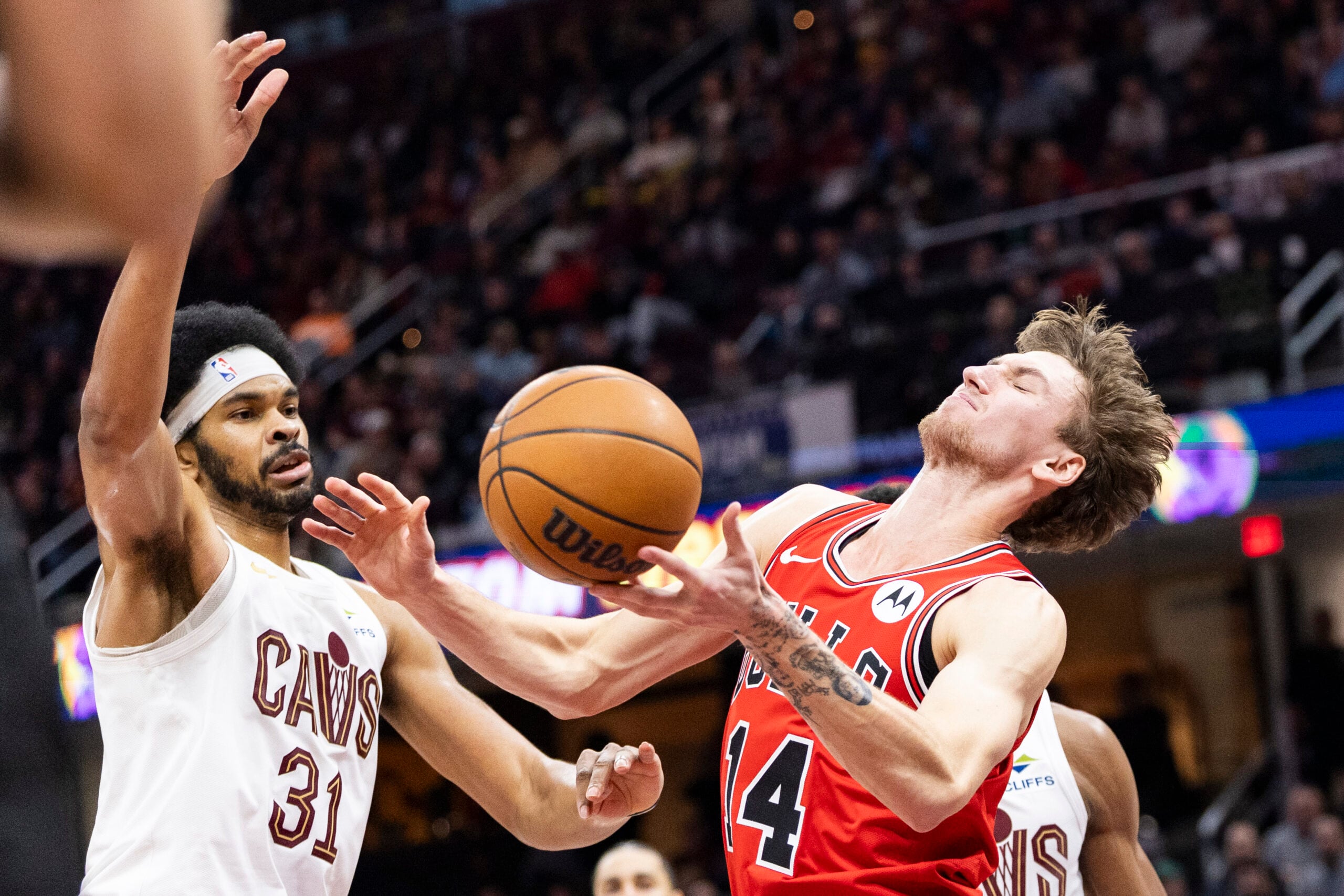 Dec 19, 2025; Cleveland, Ohio, USA; Chicago Bulls forward Matas Buzelis (14) loses the ball against Cleveland Cavaliers center Jarrett Allen (31) during the third quarter at Rocket Arena. Mandatory Credit: Scott Galvin-Imagn Images