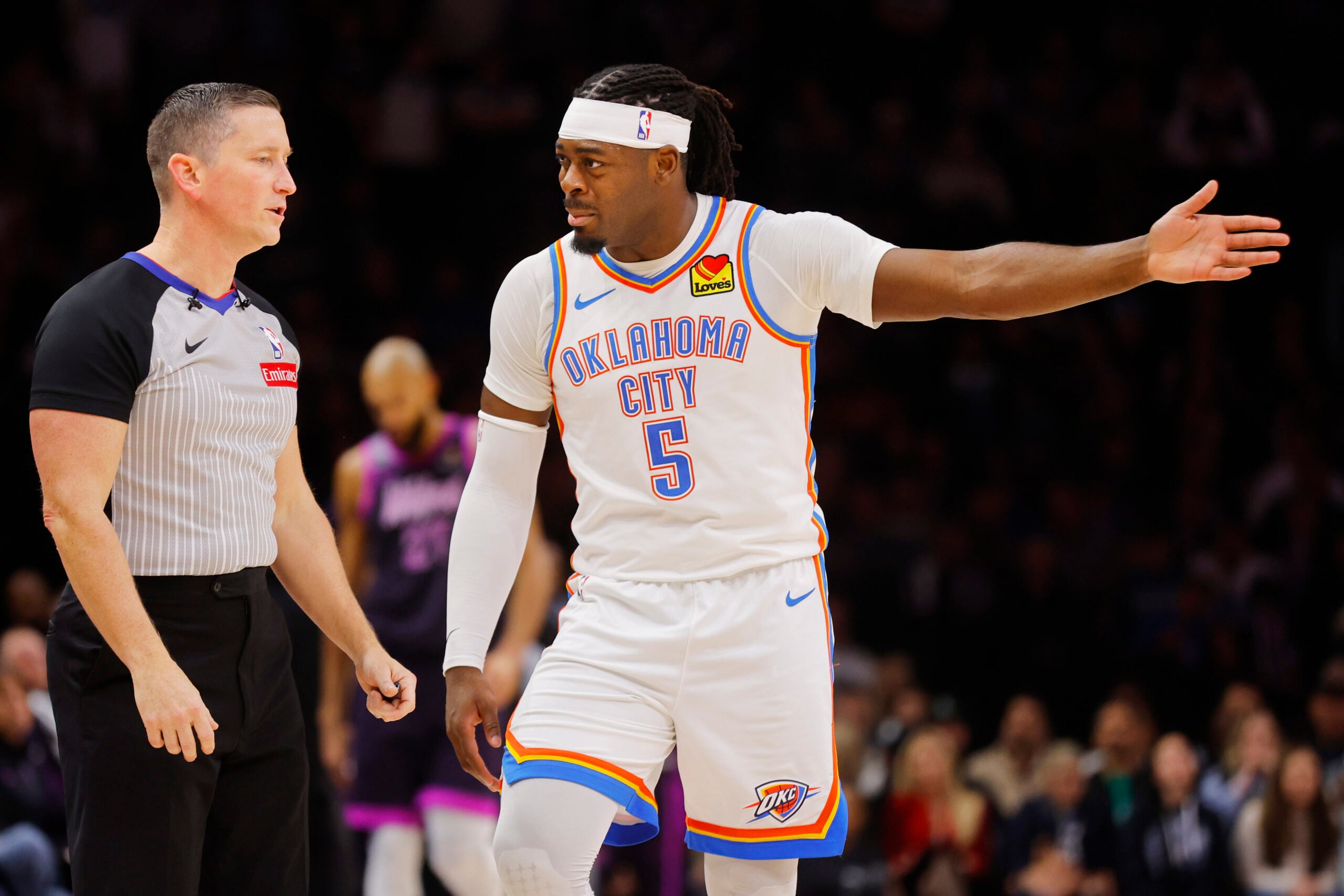 Dec 19, 2025; Minneapolis, Minnesota, USA; Oklahoma City Thunder forward Luguentz Dort (5) questions referee Nick Buchert on a call for the Minnesota Timberwolves in the fourth quarter at Target Center. Mandatory Credit: Bruce Kluckhohn-Imagn Images
