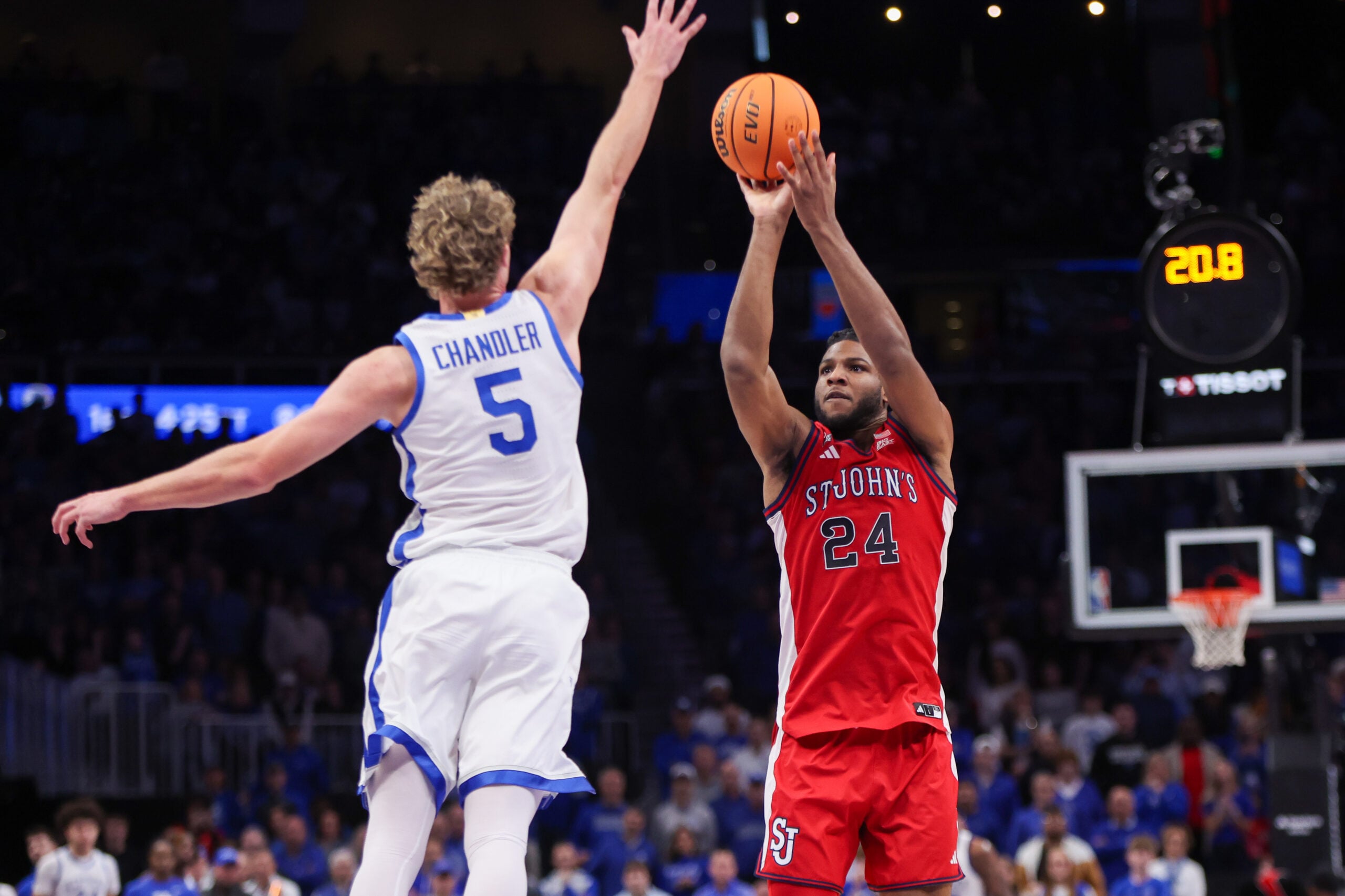 Dec 20, 2025; Atlanta, Georgia, USA; St. John Red Storm forward Bryce Hopkins (23) shoots past Kentucky Wildcats guard Collin Chandler (5) in the second half at State Farm Arena. Mandatory Credit: Brett Davis-Imagn Images