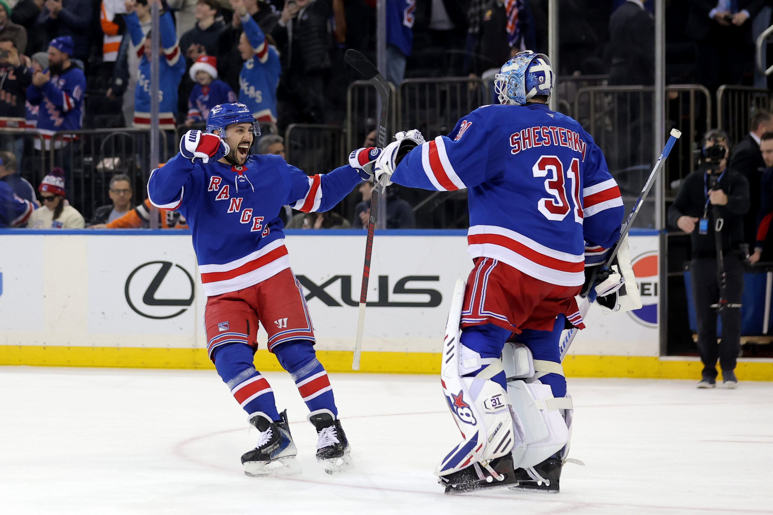 Dec 20, 2025; New York, New York, USA; New York Rangers center Vincent Trocheck (16) celebrates with goaltender Igor Shesterkin (31) after defeating the Philadelphia Flyers in a shootout at Madison Square Garden. Mandatory Credit: Brad Penner-Imagn Images
