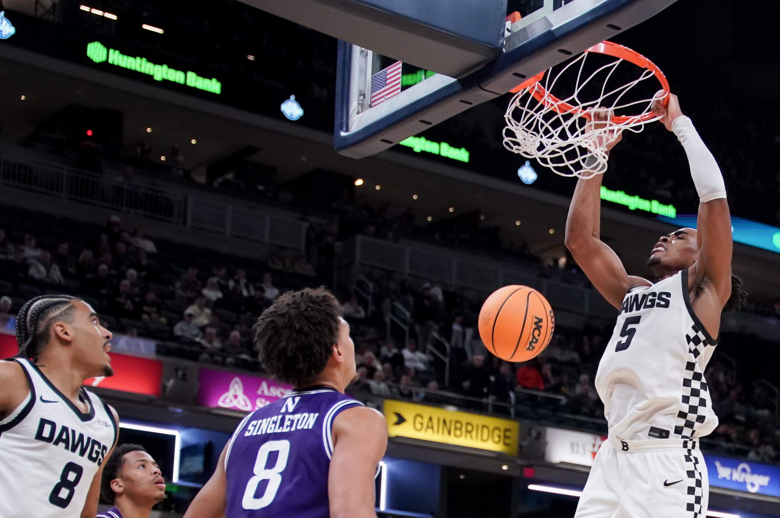 Dec 20, 2025; Indianapolis, Indiana, USA; Butler Bulldogs forward Michael Ajayi (5) dunks the ball against Northwestern Wildcats forward Tre Singleton (8) during the second half at Gainbridge Fieldhouse. Mandatory Credit: Robert Goddin-Imagn Images