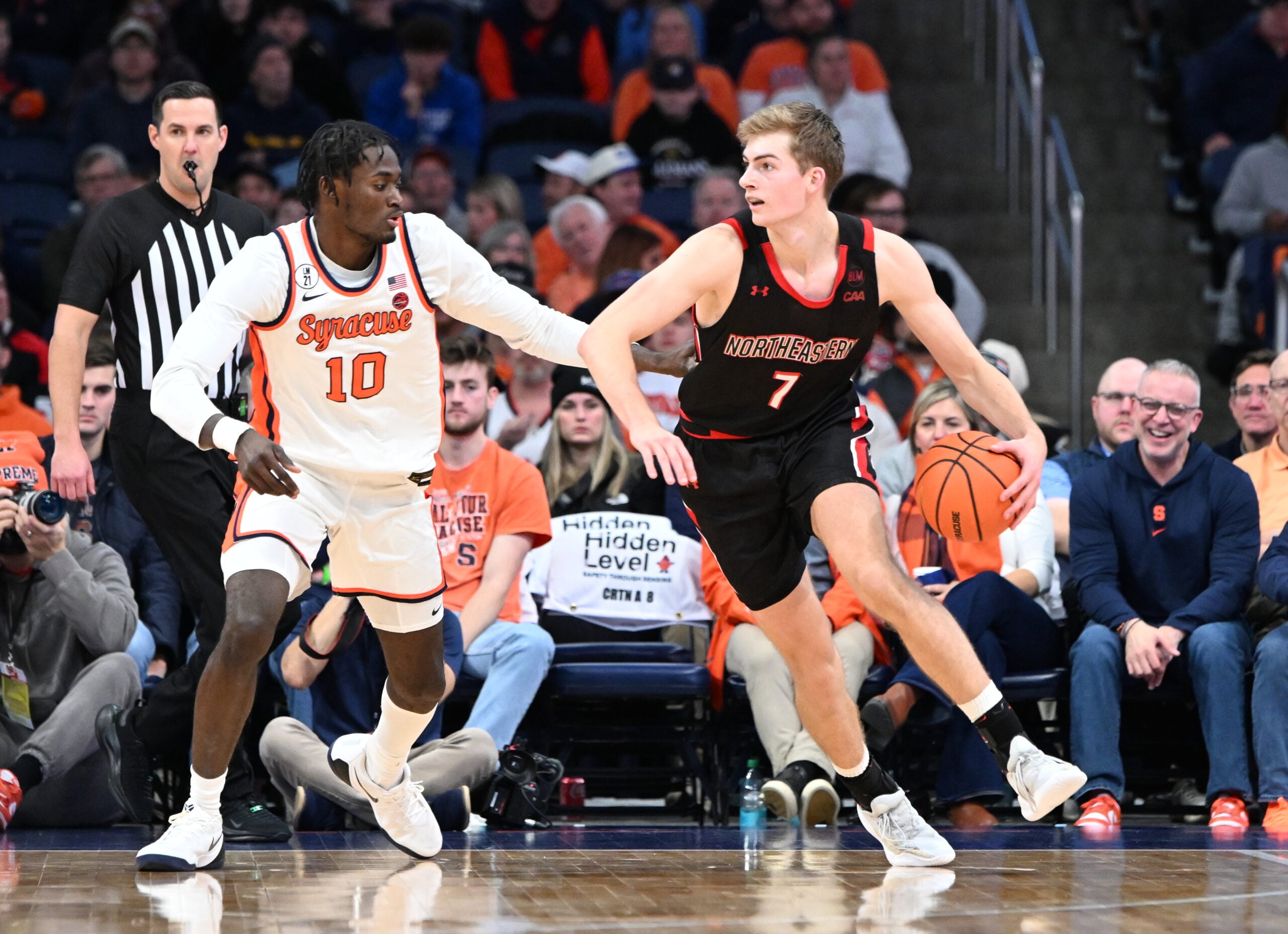 Dec 20, 2025; Syracuse, New York, USA; Northeastern Huskies forward Youri Fritz (7) handles the ball against Syracuse Orange forward Ibrahim Souare (10) in the second half at the JMA Wireless Dome. Mandatory Credit: Mark Konezny-Imagn Images