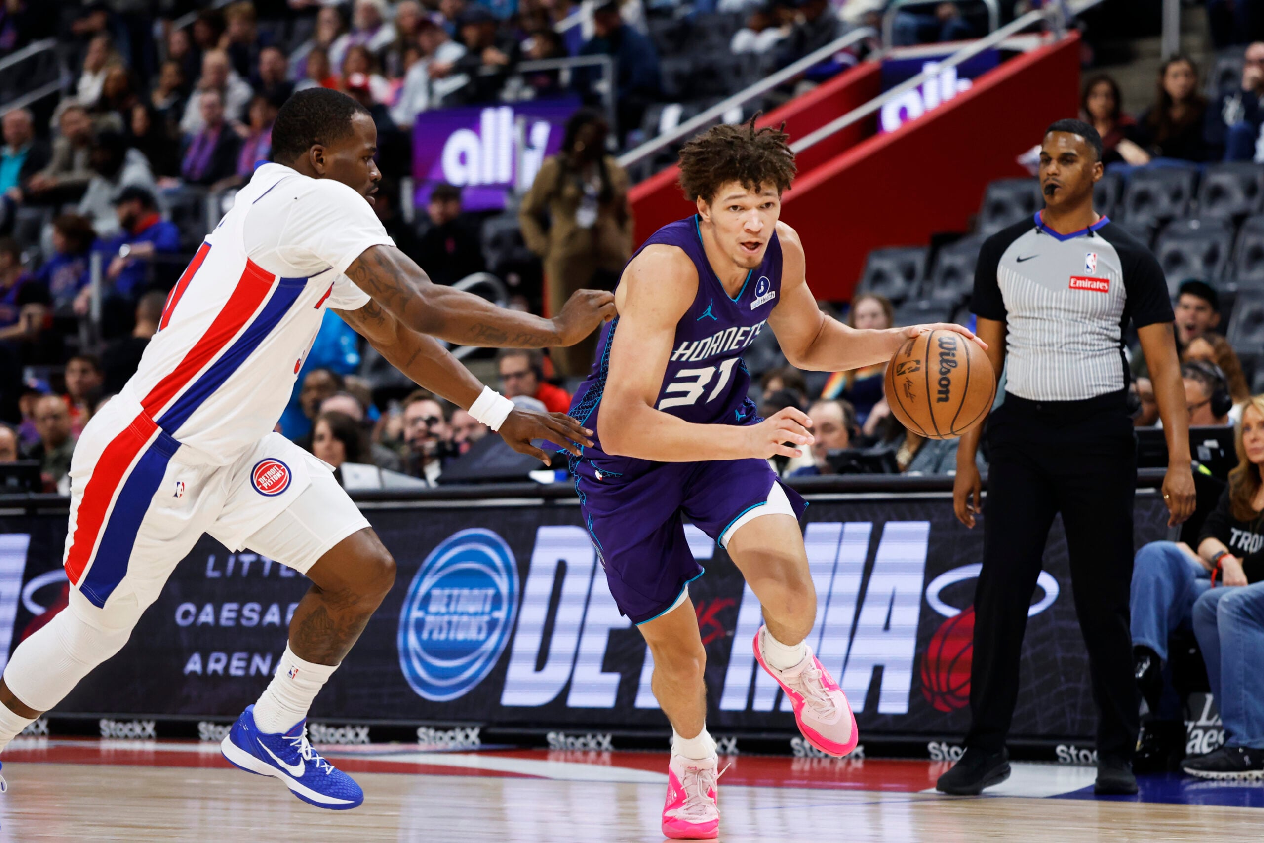 Dec 20, 2025; Detroit, Michigan, USA; Charlotte Hornets forward Tidjane Salaun (31) dribbles defended by Detroit Pistons guard Javonte Green (31) in the second half at Little Caesars Arena. Mandatory Credit: Rick Osentoski-Imagn Images