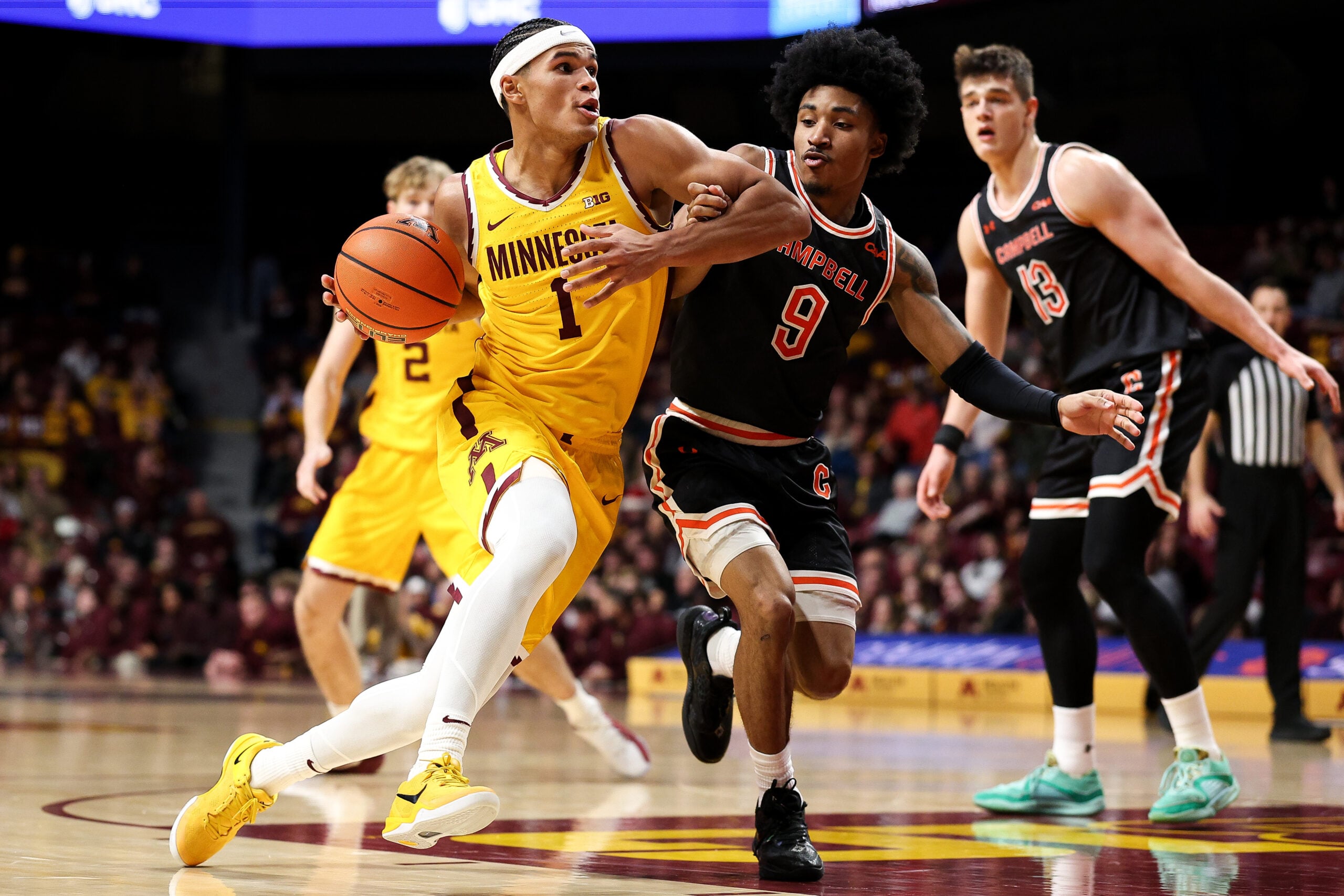 Dec 21, 2025; Minneapolis, Minnesota, USA; Minnesota Golden Gophers guard Isaac Asuma (1) works around Campbell Fighting Camels guard D.J. Smith (9) during the first half at Williams Arena. Mandatory Credit: Matt Krohn-Imagn Images