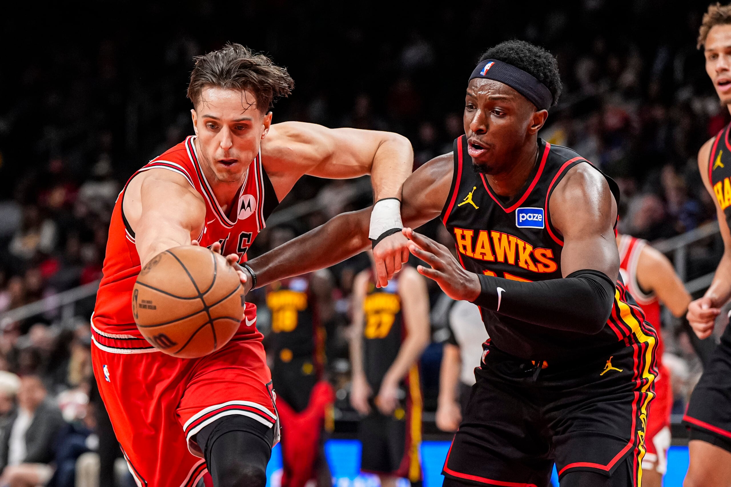 Dec 21, 2025; Atlanta, Georgia, USA; Chicago Bulls forward Zach Collins (12) and Atlanta Hawks forward Onyeka Okongwu (17) fight for the ball during the second half at State Farm Arena. Mandatory Credit: Dale Zanine-Imagn Images