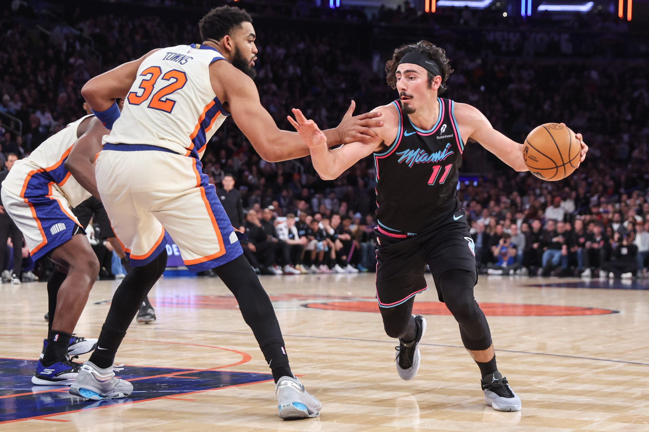Dec 21, 2025; New York, New York, USA; Miami Heat forward Jaime Jaquez Jr. (11) looks to drive past New York Knicks center Karl-Anthony Towns (32) in the fourth quarter at Madison Square Garden. Mandatory Credit: Wendell Cruz-Imagn Images