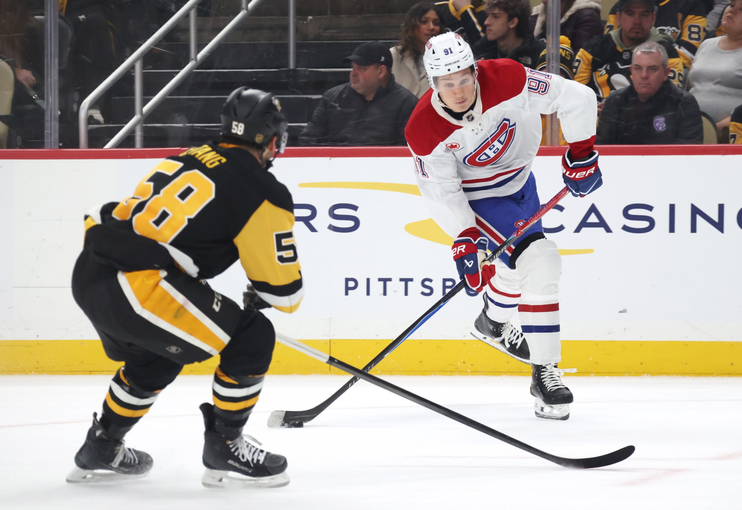 Dec 21, 2025; Pittsburgh, Pennsylvania, USA; Montréal Canadiens center Oliver Kapanen (91) shoots the puck as Pittsburgh Penguins defenseman Kris Letang (58) defends during the second period at PPG Paints Arena. Mandatory Credit: Charles LeClaire-Imagn Images