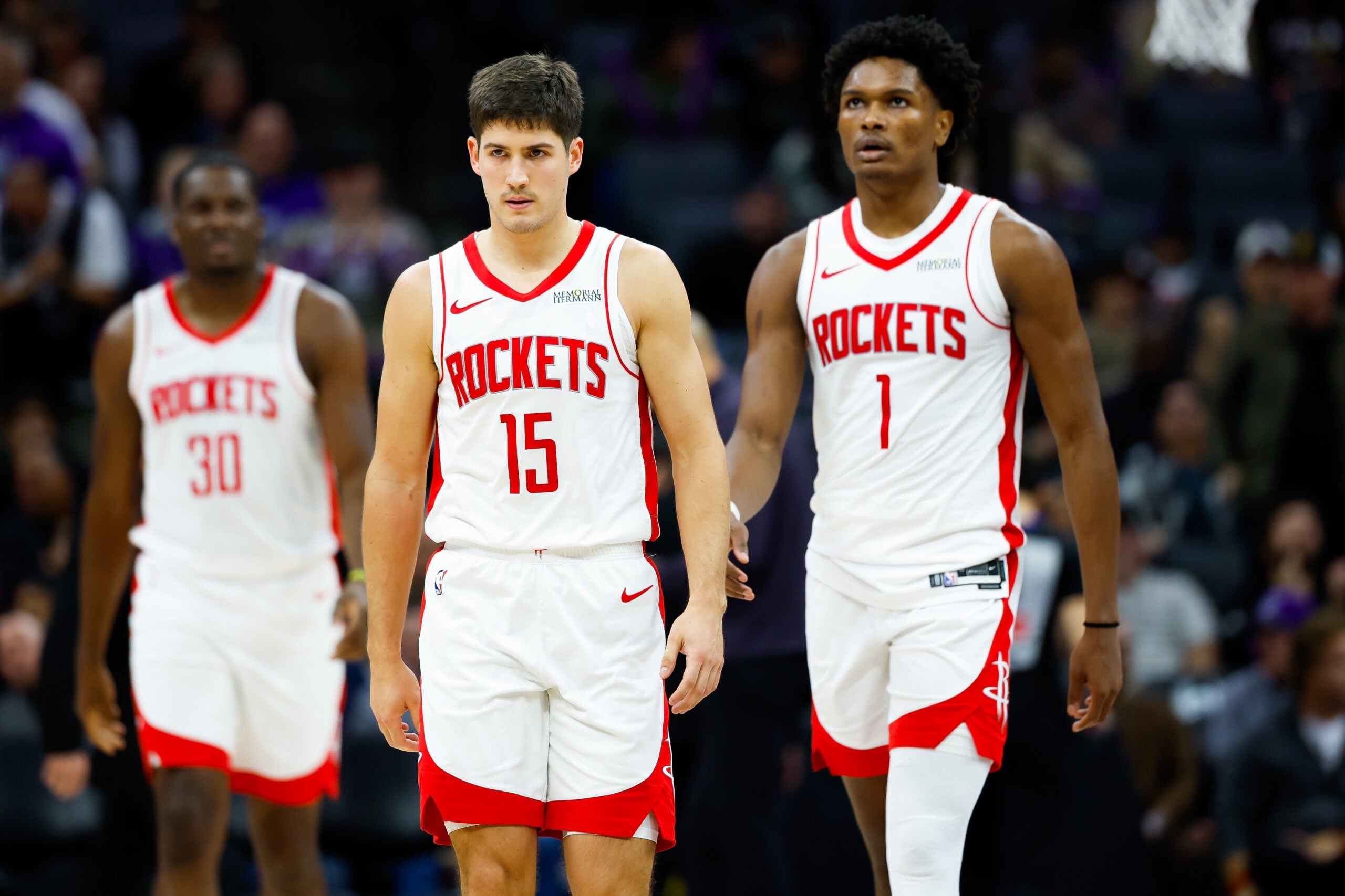 Dec 21, 2025; Sacramento, California, USA; Houston Rockets guard Reed Sheppard (15) and guard Amen Thompson (1) walk off the court for a time out during the fourth quarter against the Sacramento Kings at Golden 1 Center. Mandatory Credit: Sergio Estrada-Imagn Images