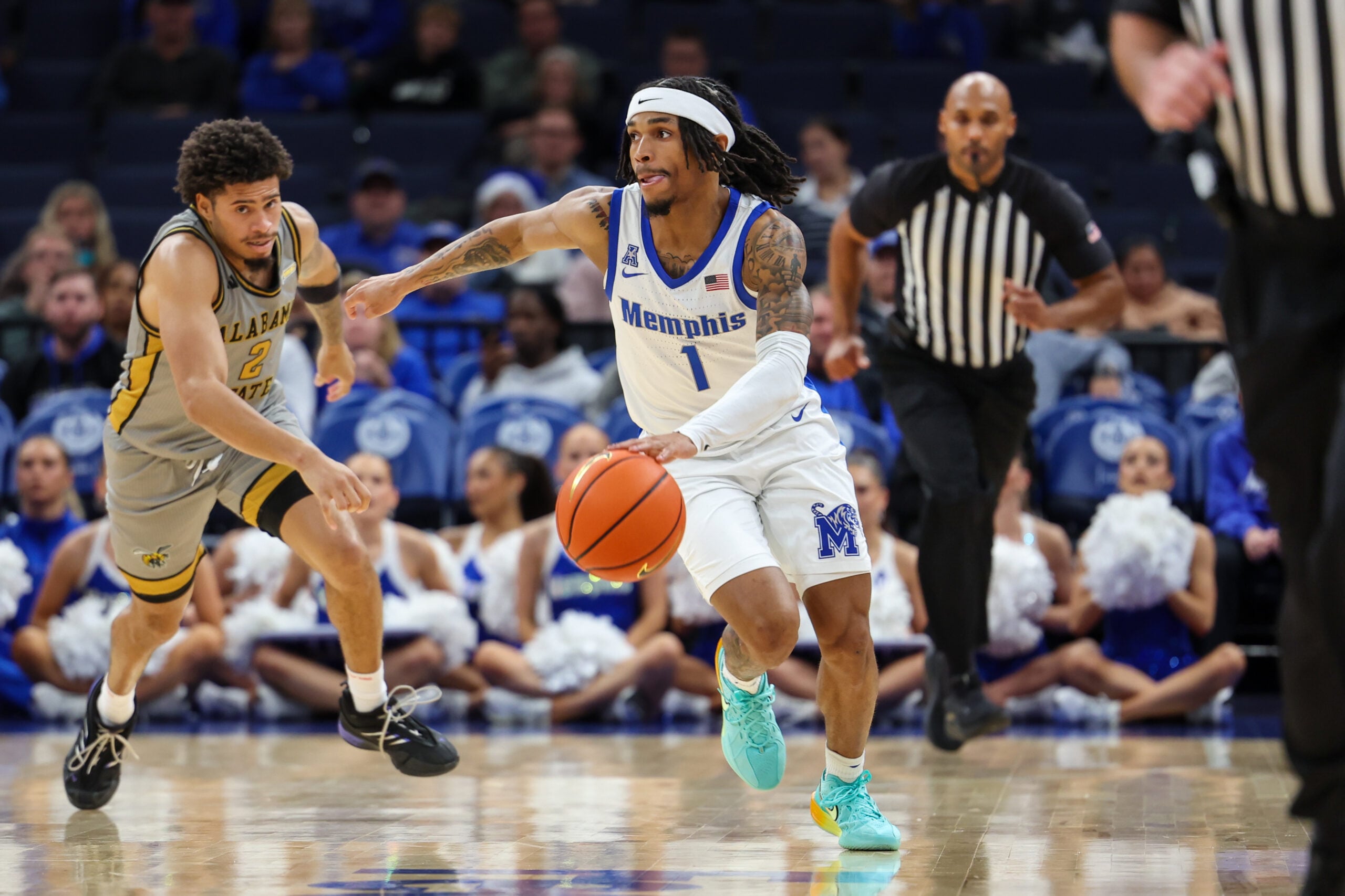 Dec 22, 2025; Memphis, Tennessee, USA; Memphis Tigers guard Dug McDaniel (1) drives against Alabama State Hornets guard Micah Simpson (2) during the second half at FedExForum. Mandatory Credit: Wesley Hale-Imagn Images