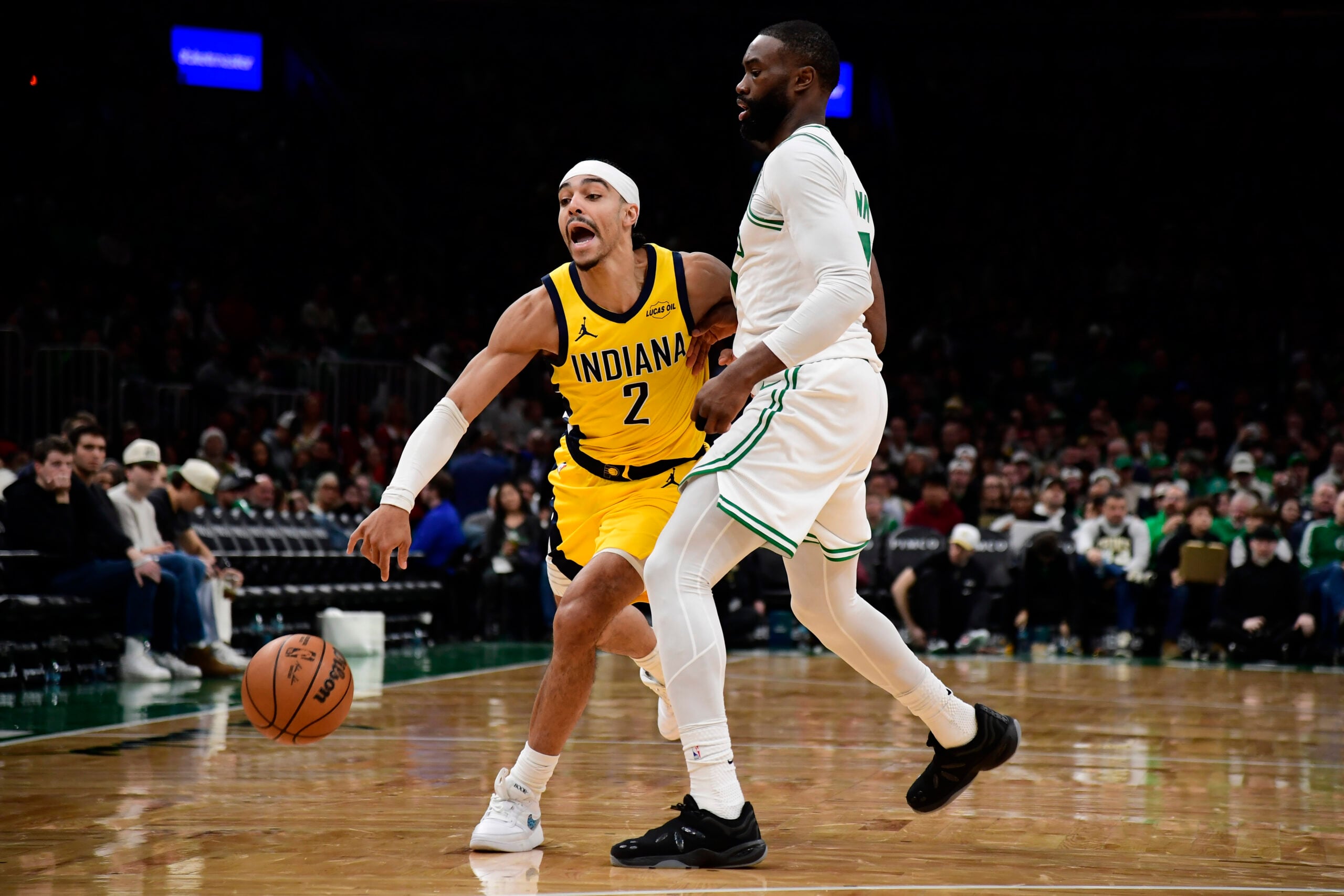Dec 22, 2025; Boston, Massachusetts, USA; Boston Celtics guard Jaylen Brown (7) defends Indiana Pacers guard Andrew Nembhard (2) during the second half at TD Garden. Mandatory Credit: Bob DeChiara-Imagn Images