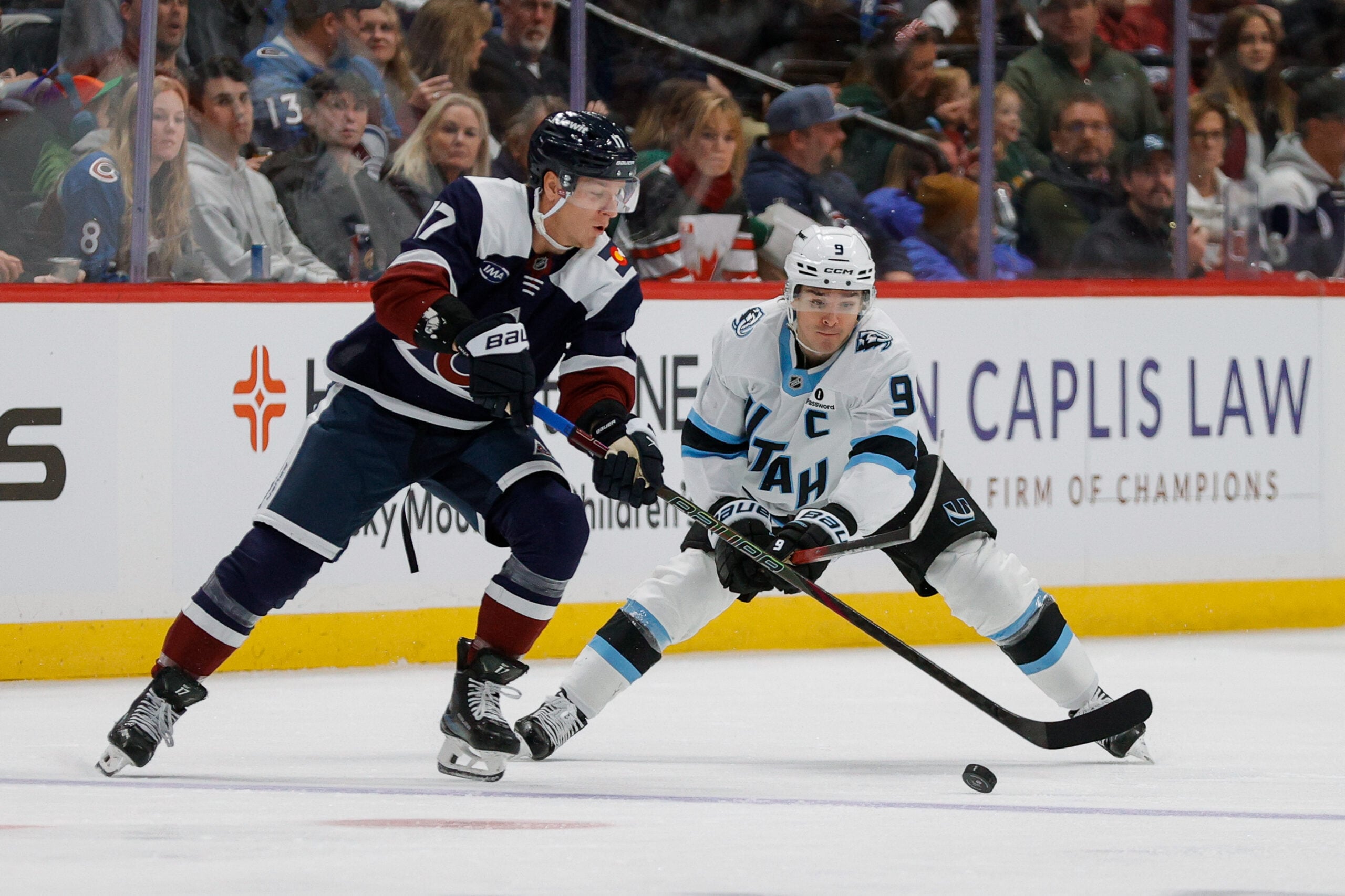 Dec 23, 2025; Denver, Colorado, USA; Colorado Avalanche center Parker Kelly (17) controls the puck ahead of Utah Mammoth right wing Clayton Keller (9) in the second period at Ball Arena. Mandatory Credit: Isaiah J. Downing-Imagn Images