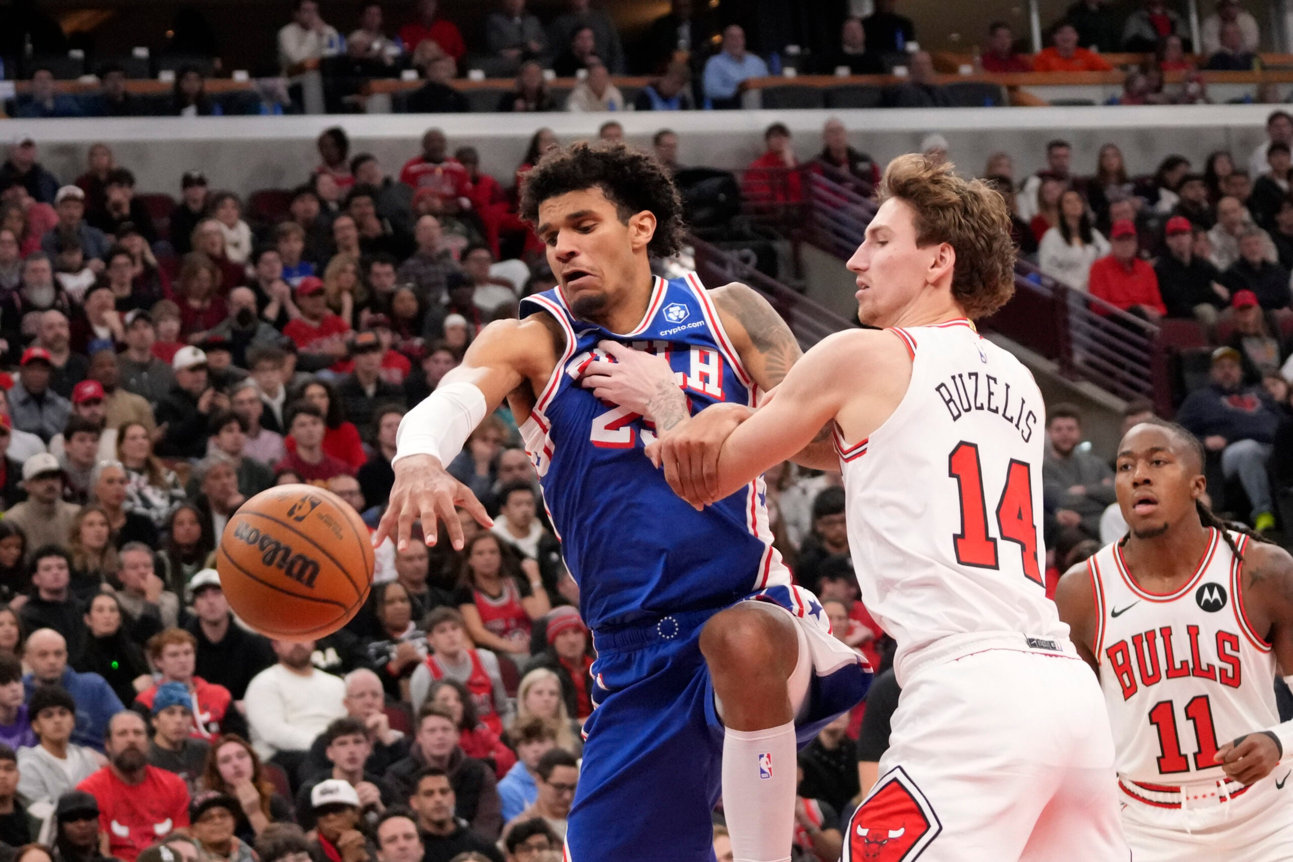Dec 26, 2025; Chicago, Illinois, USA; Chicago Bulls forward Matas Buzelis (14) defends Philadelphia 76ers forward Dominick Barlow (25) during the second half at United Center. Mandatory Credit: David Banks-Imagn Images