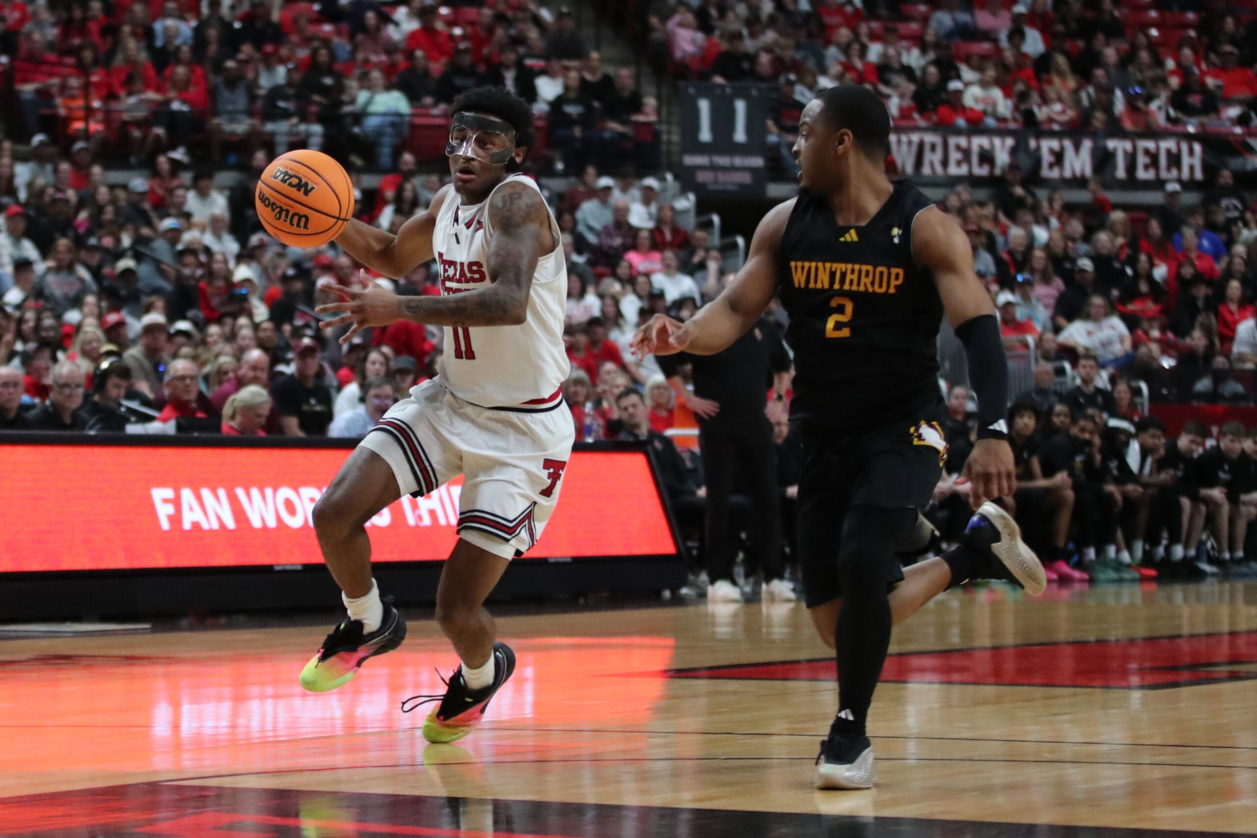 Dec 28, 2025; Lubbock, Texas, USA; Texas Tech Red Raiders guard Jaylen Petty (11) races down court against Winthrop Eagles guard Kareem Rozier (2) in the second half at United Supermarkets Arena. Mandatory Credit: Michael C. Johnson-Imagn Images
