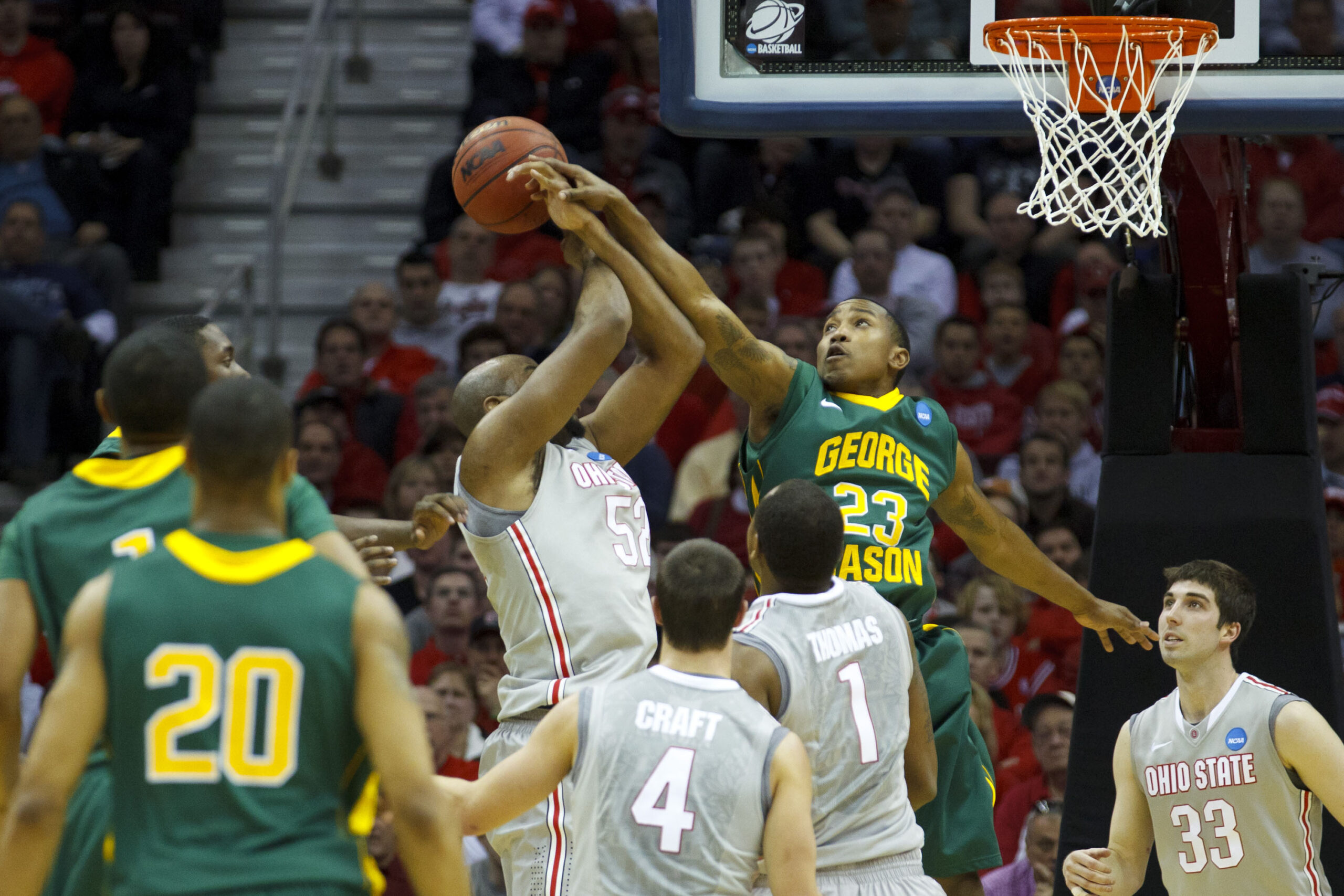 Mar 20, 2011; Cleveland, OH, USA; George Mason Patriots guard Rashad Whack (23) fouls Ohio State Buckeyes forward Dallas Lauderdale (52) as he shoots during the third round of the 2011 NCAA men's basketball tournament at Quicken Loans Arena. Mandatory Credit: Rick Osentoski-Imagn Images