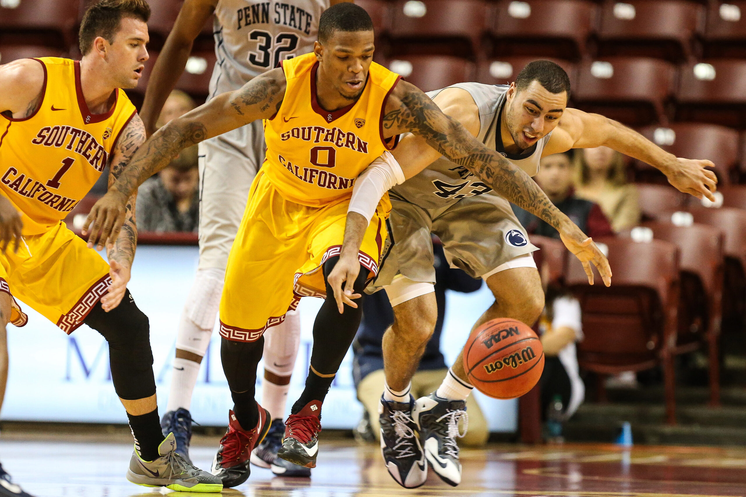 Nov 23, 2014; Charleston, SC, USA; USC Trojans forward Darion Clark (0) and Penn State Nittany Lions forward Ross Travis (43) fight for the ball during the second period at TD Arena. Mandatory Credit: Jim Dedmon-Imagn Images