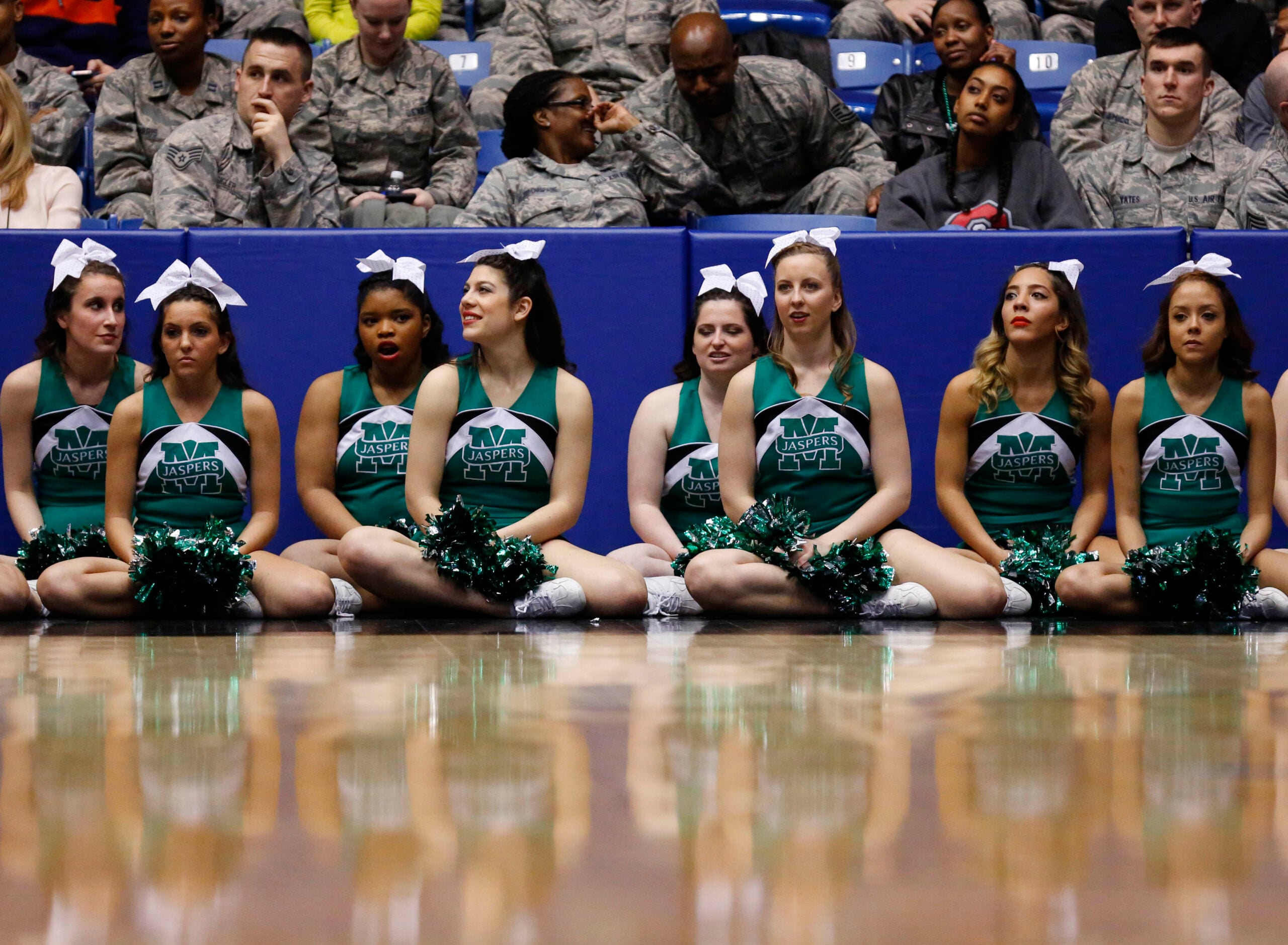 Mar 17, 2015; Dayton, OH, USA; Manhattan Jaspers cheerleaders sit court side during the first half against the Hampton Pirates in the first round of the 2015 NCAA Tournament at UD Arena. Mandatory Credit: Rick Osentoski-Imagn Images