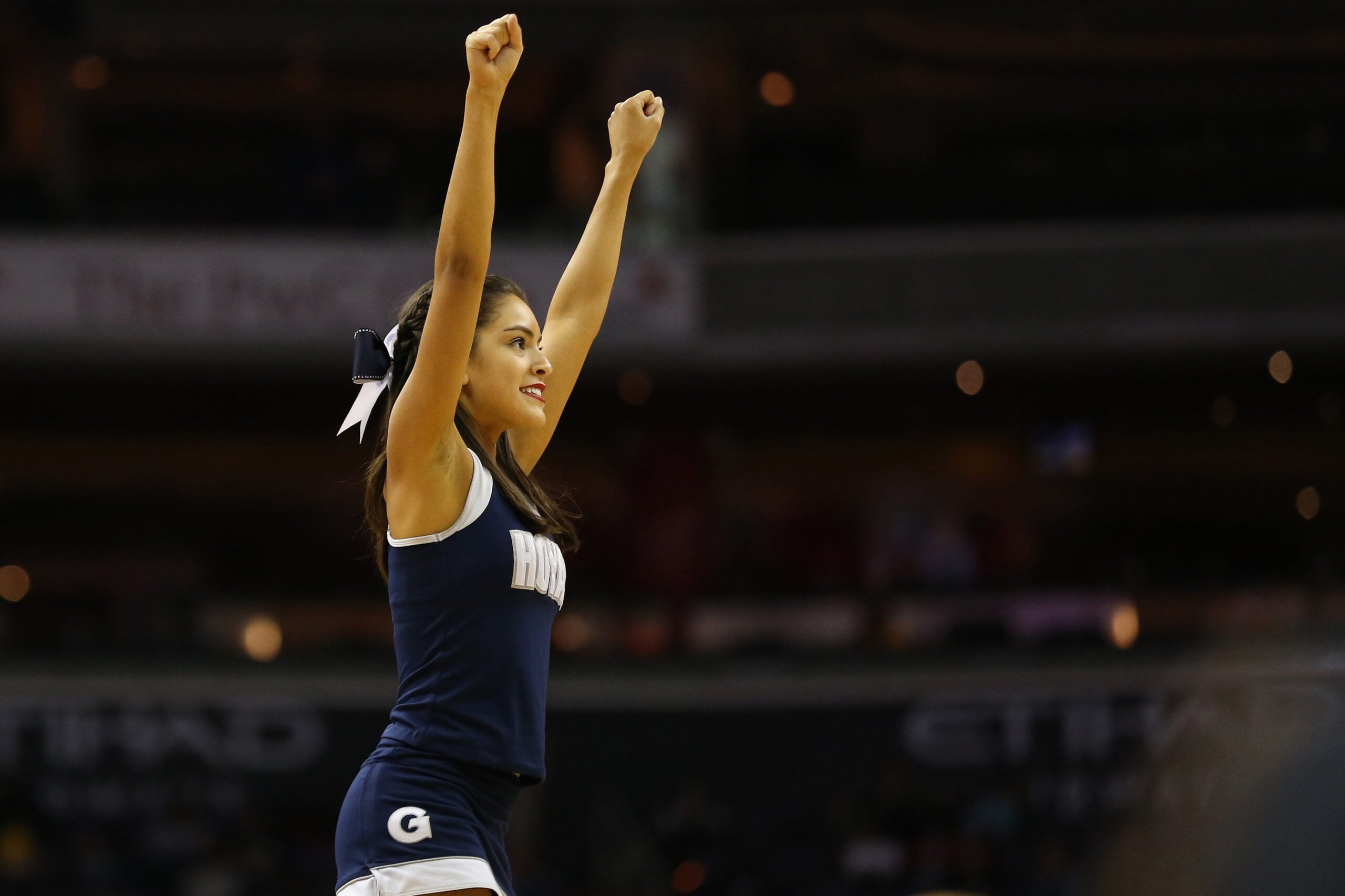 Feb 11, 2017; Washington, DC, USA; A Georgetown Hoyas cheerleader waves to fans in the stands during a timeout against the Marquette Golden Eagles in the second half at Verizon Center. The Hoyas won 80-62. Mandatory Credit: Geoff Burke-Imagn Images