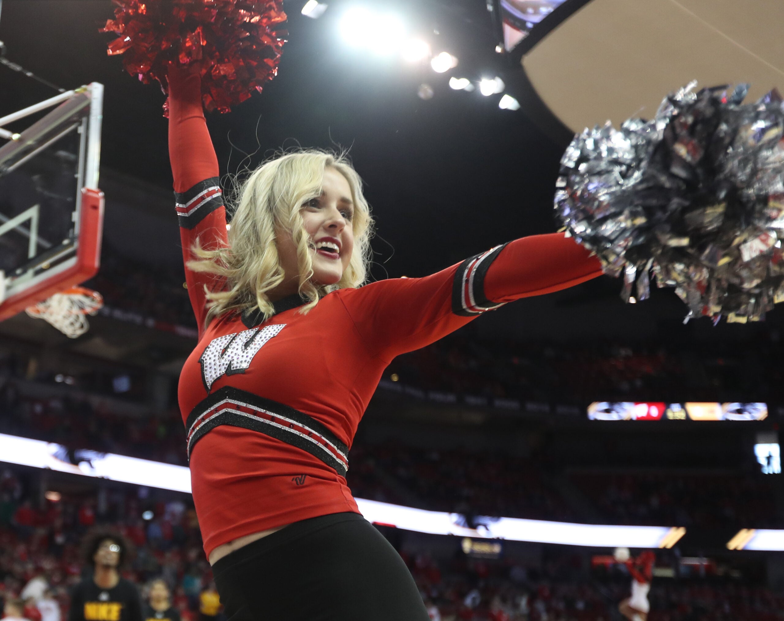 Dec 21, 2019; Madison, Wisconsin, USA; A Wisconsin Badgers cheerleader entertains the fans before the game with the Wisconsin Milwaukee Panthers at the Kohl Center. Mandatory Credit: Mary Langenfeld-Imagn Images