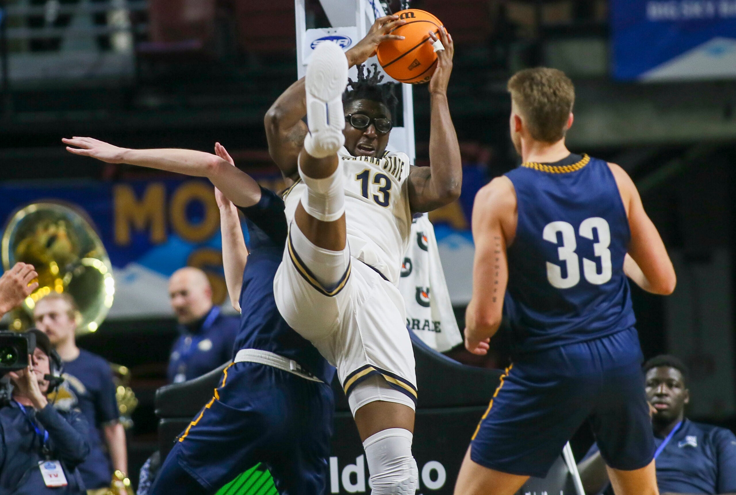 Mar 8, 2023; Boise, ID, USA; Montana State Bobcats forward Jubrile Belo (13) brings down a rebound during the second half against Northern Arizona Lumberjacks at Idaho Central Arena. Montana State defeated Northern Arizona 85-78. Mandatory Credit: Brian Losness-Imagn Images