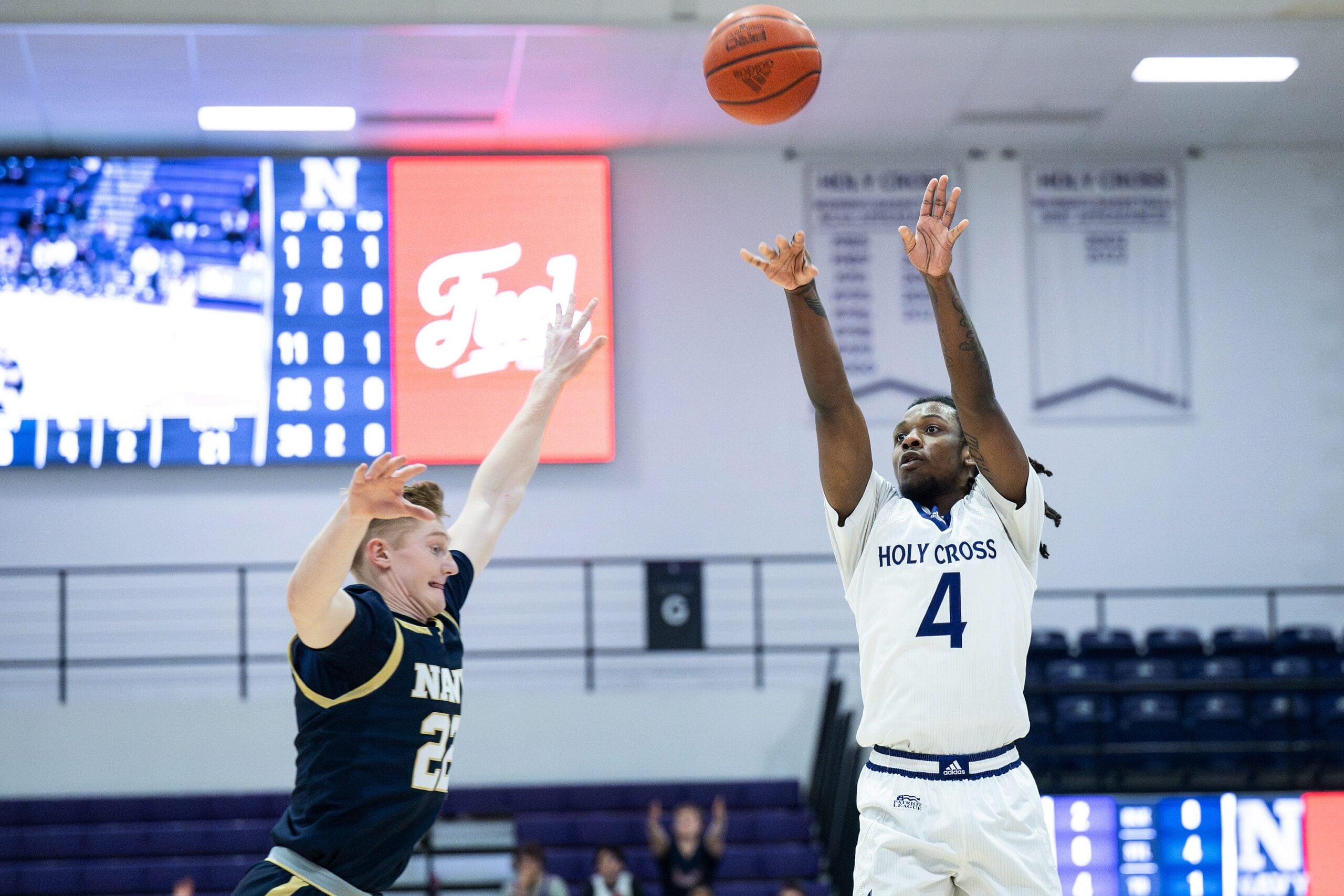 Holy Cross' Kahlil Singleton shoots as Navy's Mac MacDonald defends during Wednesday night's game at the Hart Center.