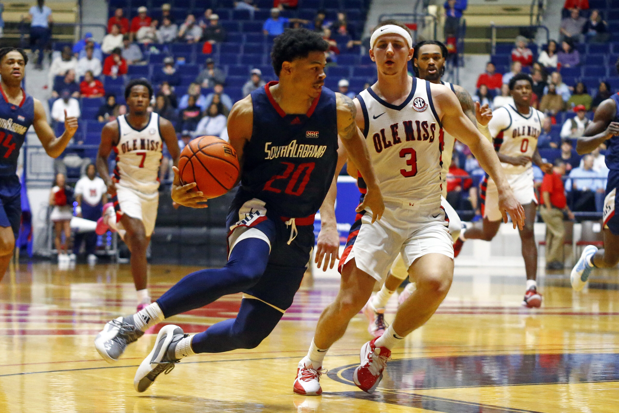 Nov 12, 2024; Oxford, Mississippi, USA; South Alabama Jaguars guard Myles Corey (20) drives to the basket as Mississippi Rebels guard Sean Pedulla (3) defends during the second half at C.M. 'Tad' Smith Coliseum. Mandatory Credit: Petre Thomas-Imagn Images