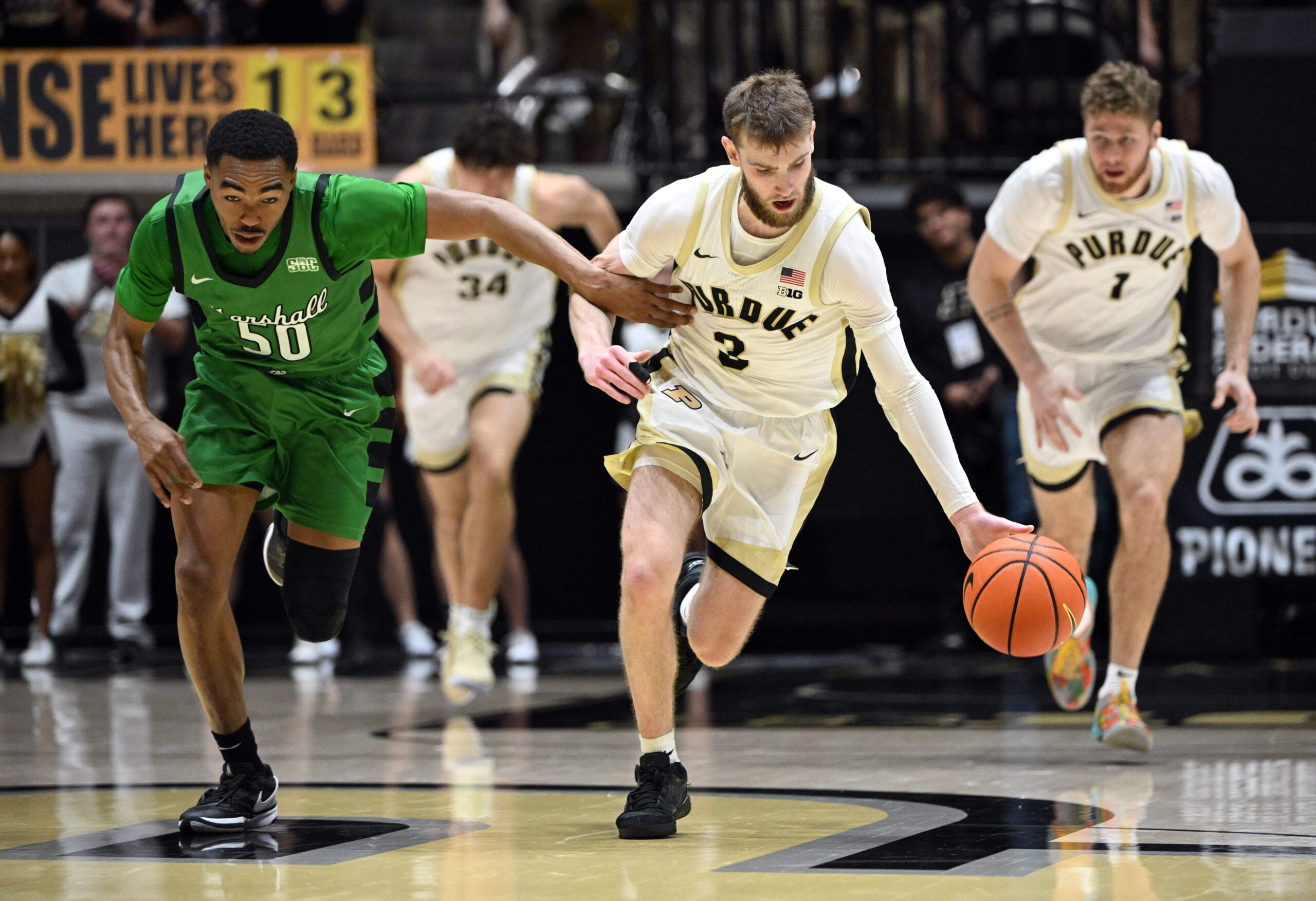 Nov 23, 2024; West Lafayette, Indiana, USA; Marshall Thundering Herd guard Jalen Speer (50) defends Purdue Boilermakers guard Braden Smith (3) back after he stole the ball during the second half at Mackey Arena. Mandatory Credit: Marc Lebryk-Imagn Images