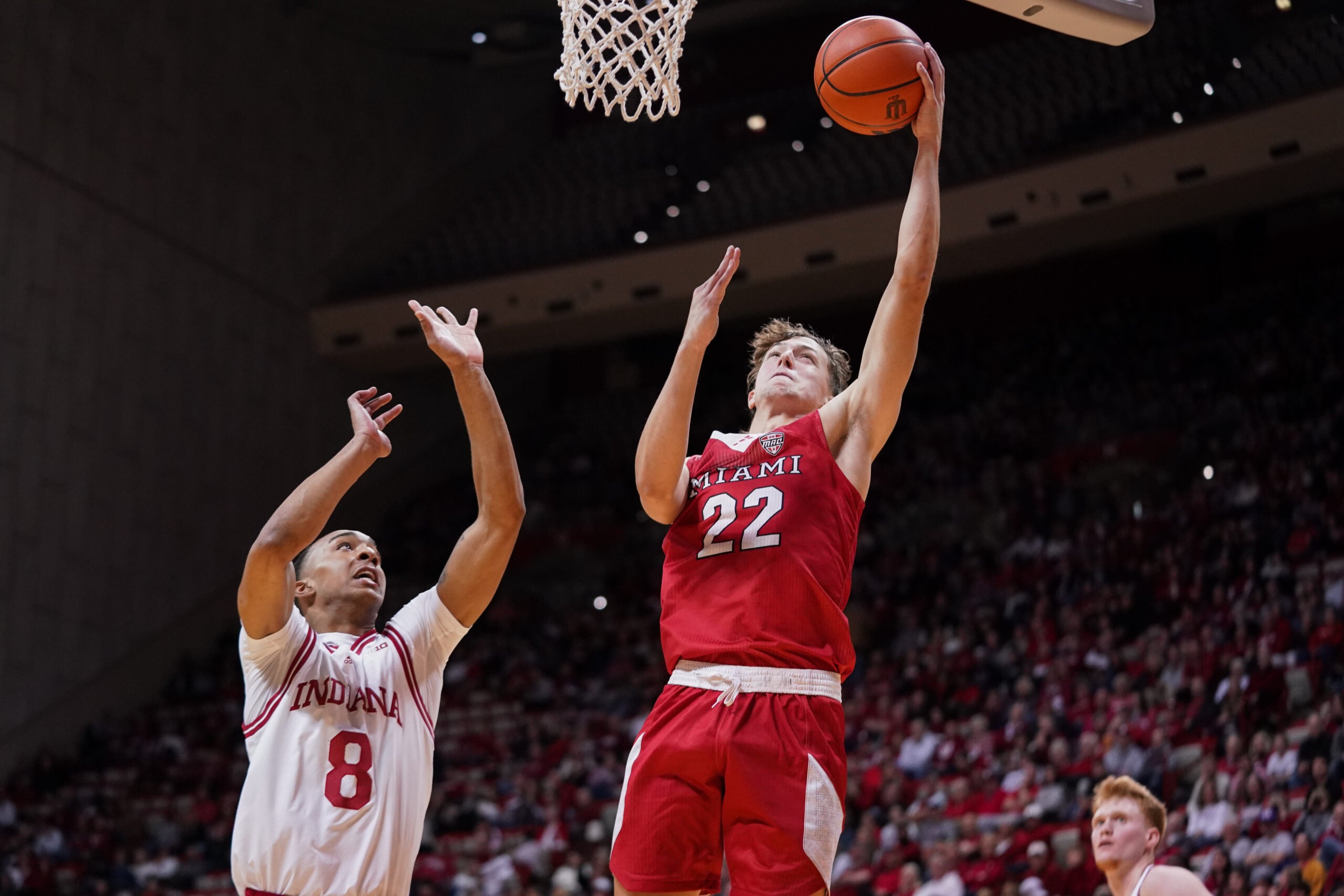 Dec 6, 2024; Bloomington, Indiana, USA; Miami (Oh) Redhawks forward Brant Byers (22) scores past Indiana Hoosiers forward Bryson Tucker (8) during the second half at Simon Skjodt Assembly Hall. Mandatory Credit: Robert Goddin-Imagn Images